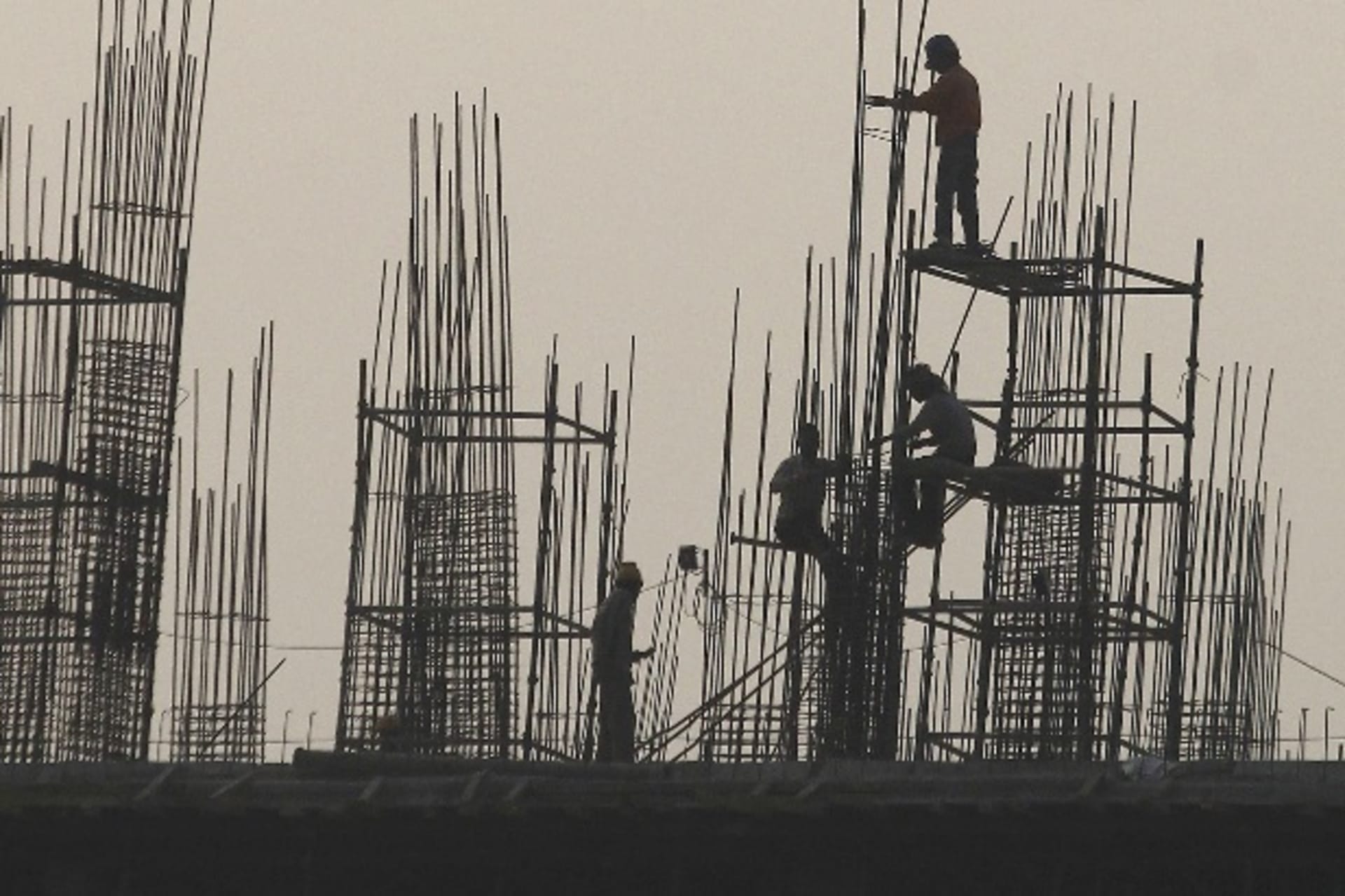 <p>Labourers work at the site of a commercial building under construction in Noida, on the outskirts of New Delhi December 13, 20… and increasingly getting – rapid increases in pay and benefits. Picture taken December 13, 2013. REUTERS/Anindito Mukherjee</p>