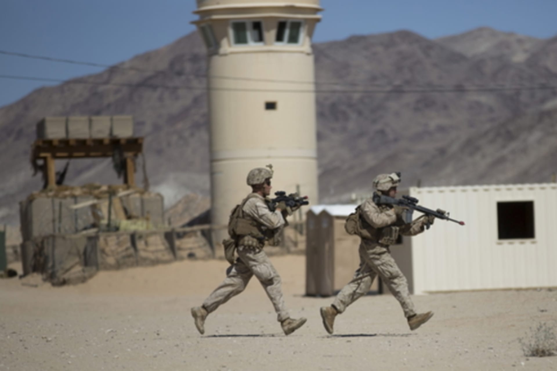 U.S. Marines from Fox Company, 2nd Battalion 1st Marines, 13th Marine Expeditionary Unit run for cover during a non-live fire MOUT training at US Marine Corps: Marines Air Ground Combat Center in Twentynine Palms