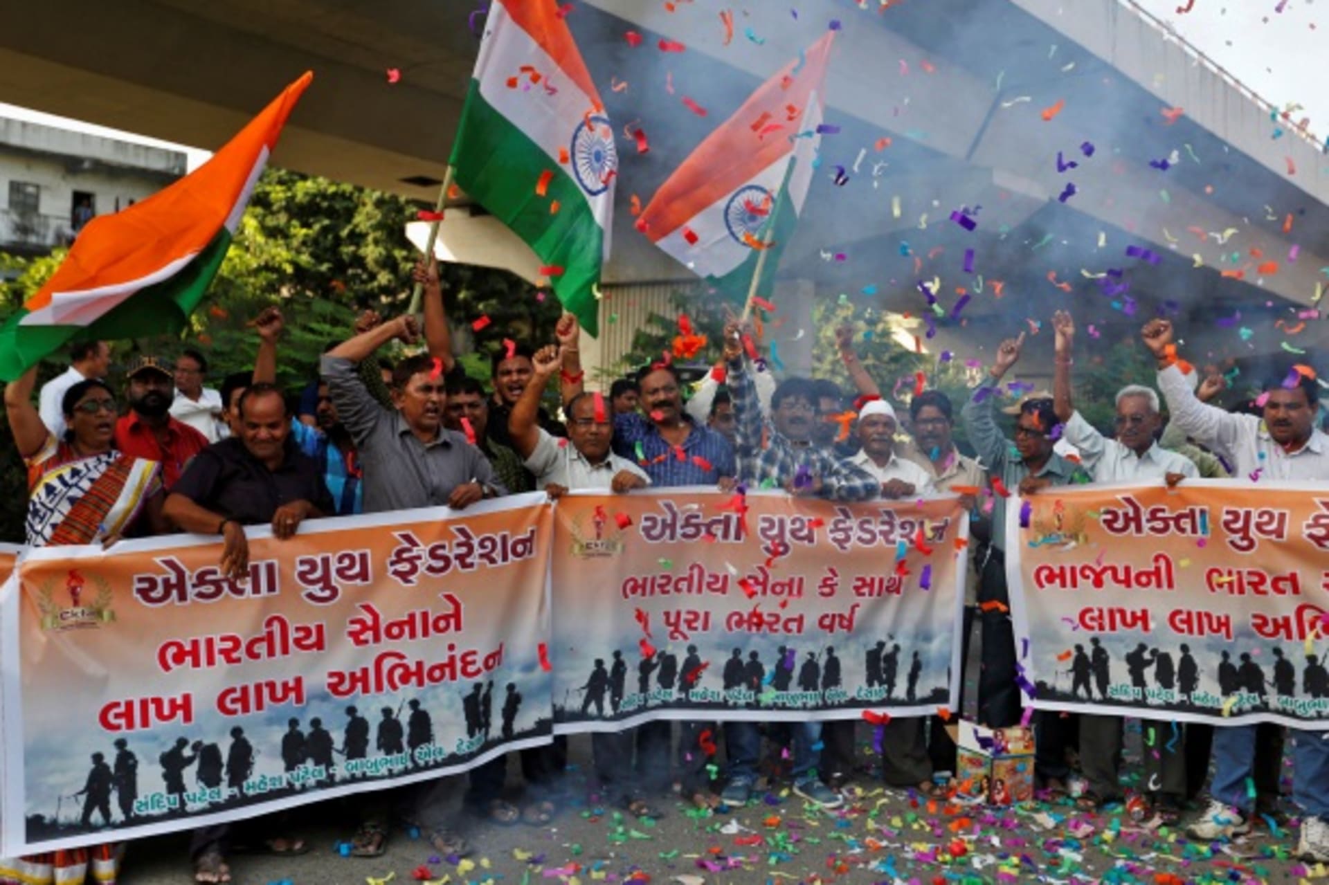 <p>People wave national flags to celebrate after India said it had conducted targeted strikes across the de facto frontier, in Ahmedabad, India, September 29, 2016.</p>
