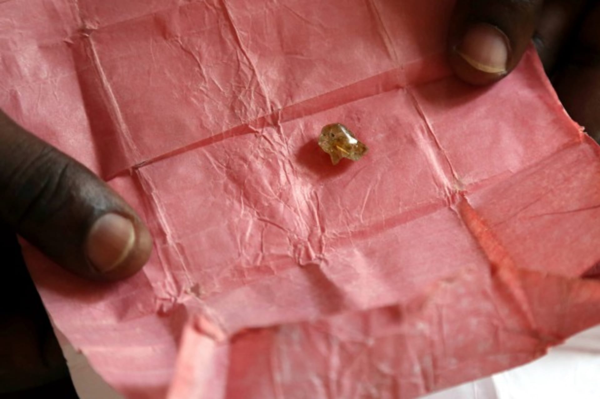 <p>A man displays a rough diamond, from the Boda region, for sale in Bangui May 1, 2014. Despite a 2013 ban on diamond exports by… in “blood diamonds”, rough diamonds are still commonly offered for sale in Central African Republic (Reuters/Emmanuel Braun).</p>
