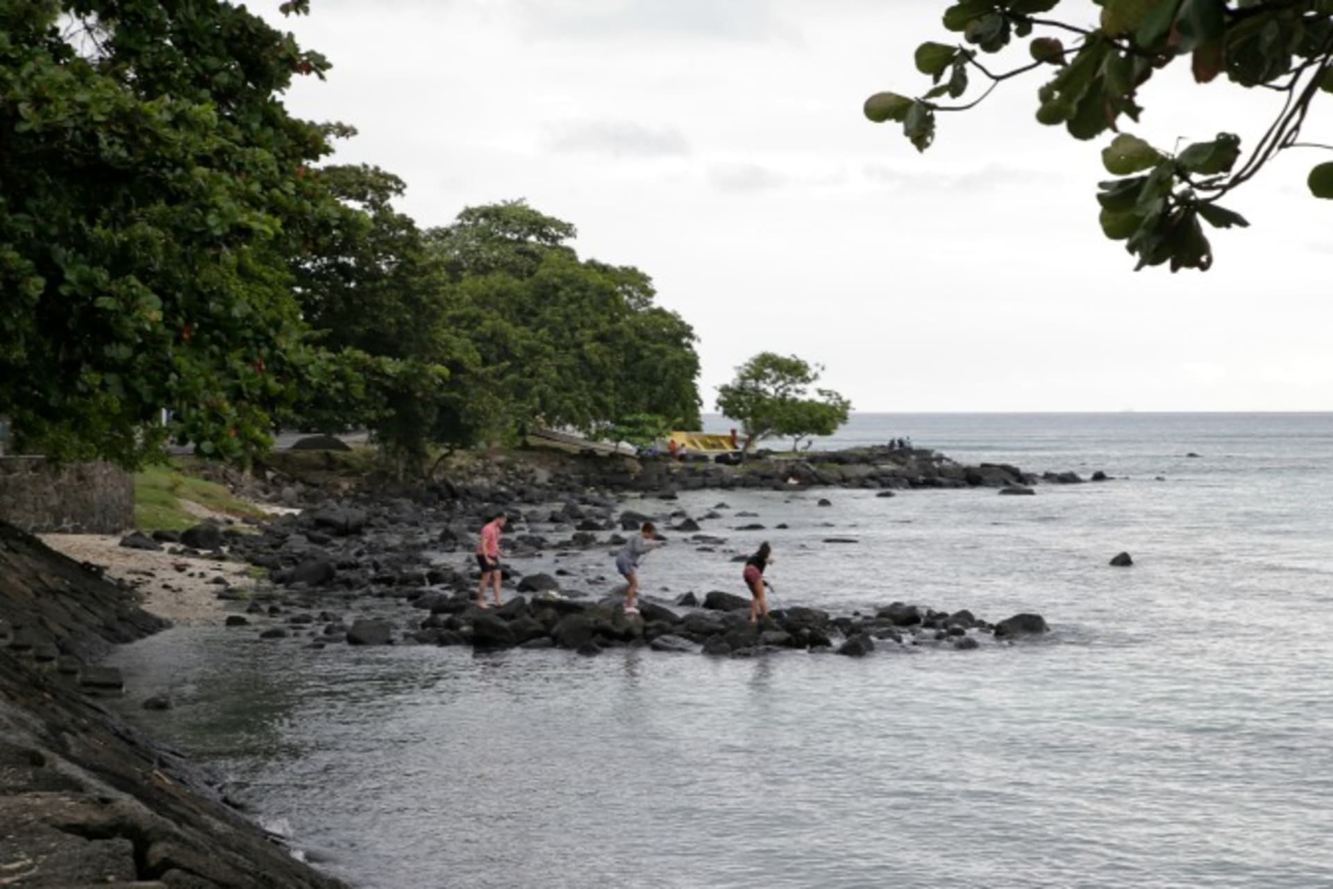 <p>People walk on the rock at the Trou aux Biches beach on the Indian Ocean island Mauritius (Reuters/Jacky Naegelen).</p>
