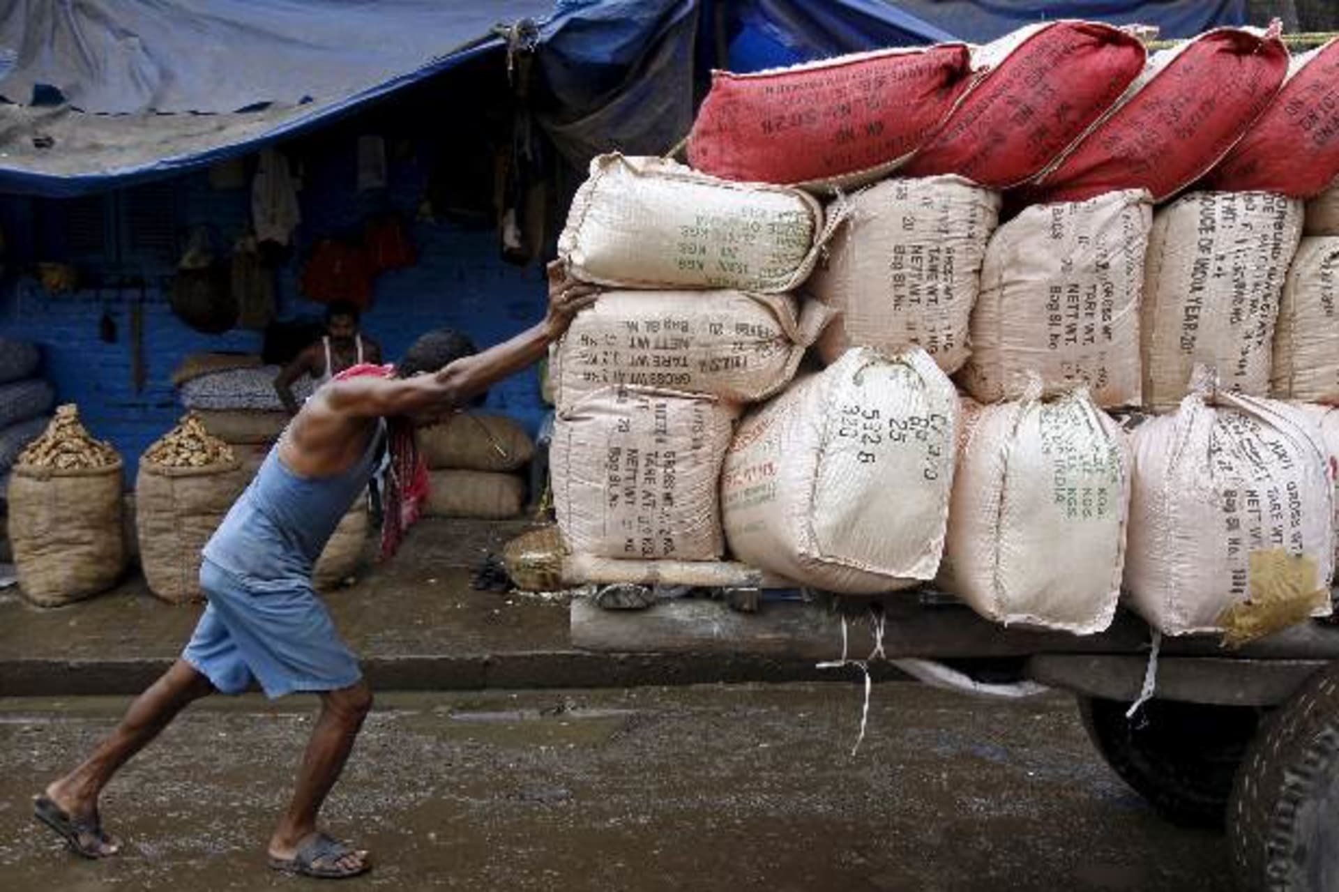 <p>A labourer pushes a handcart loaded with sacks containing tea packets, towards a supply truck at a wholesale market in Kolkata…promises that finally got a goods and services tax (GST) bill before parliament, they have turned wary (Reuters/De Chowdhuri).</p>
