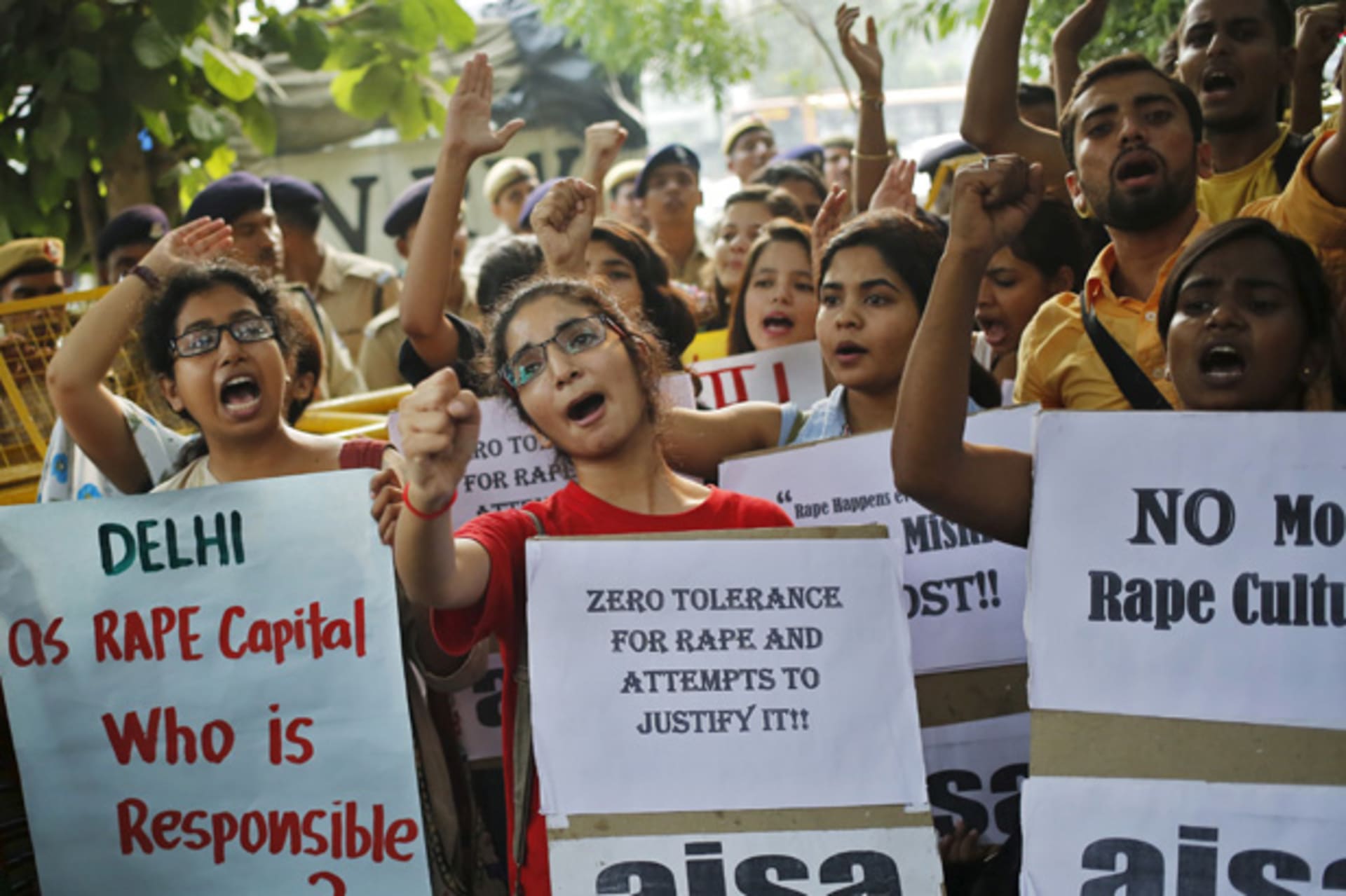 Members of AISA shout slogans as they hold placards during a protest outside police headquarters in New Delhi