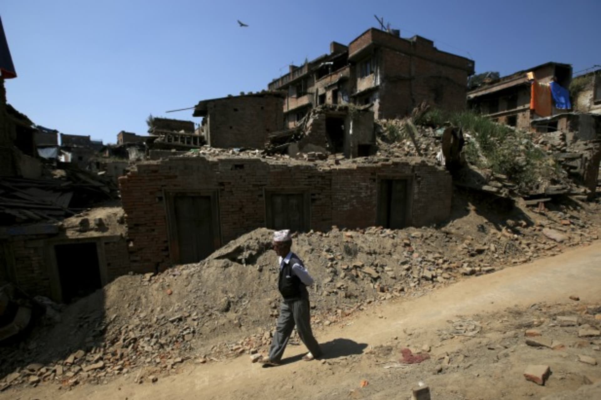 <p>A man walks past the debris of collapsed houses in Bhaktapur, Nepal October 5, 15. Twin earthquakes in April and May killed almost 9,000 people in Nepal’s worst natural disaster (Reuters/Navesh Chitrakar).</p>
