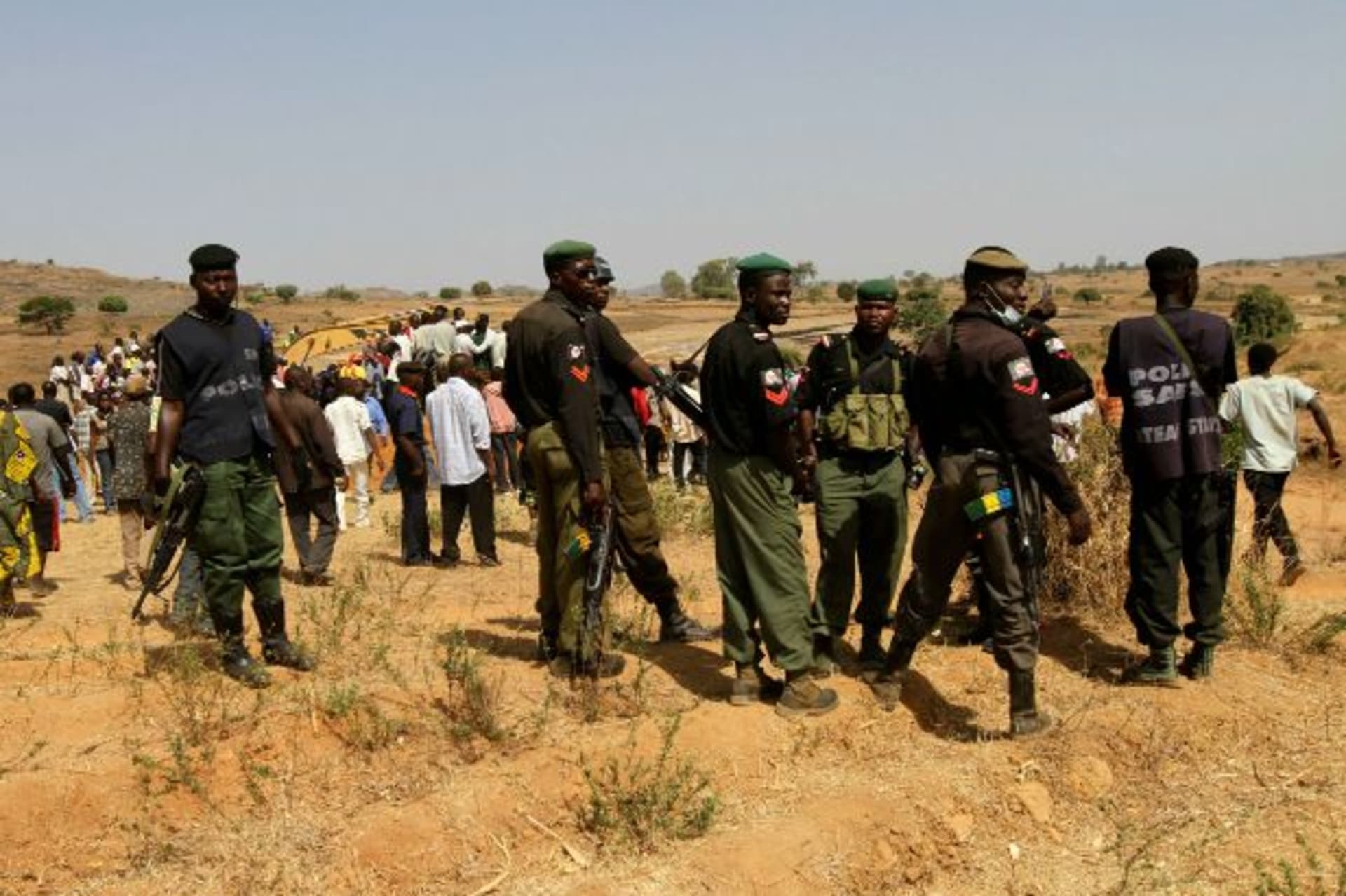 <p>Police stand guard during a mass burial of victims of religious attacks in the Dogo Nahawa village, about 15 km (9 miles) to t… attacks on outlying communities in which several hundred people were feared to have been killed (Reuters/ Akintunde Akinleye)</p>

