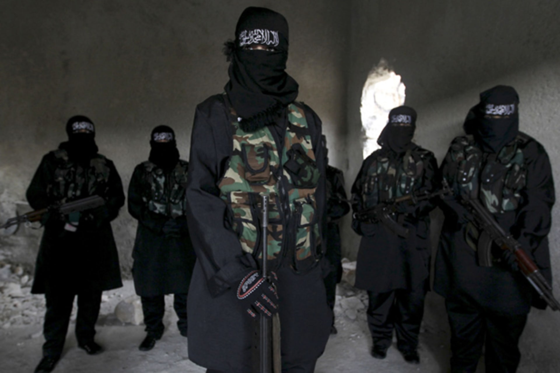 Women, who are part of the Sawt al-Haq (Voice of Rights), stand with their weapons as they undergo military training in Aleppo