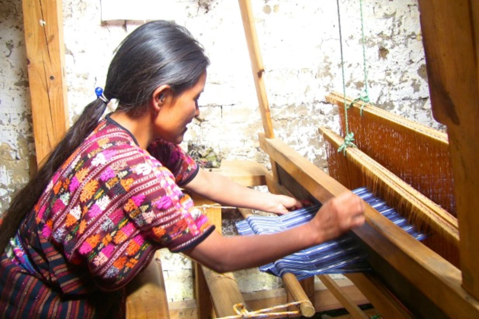 <p>An entrepreneur in Guatemala works on her loom. She received support from Friendship Bridge, a client of MCE Social Capital that provides impoverished Guatemalan women microfinance and education services, 2013. (Courtesy Friendship Bridge)</p>
