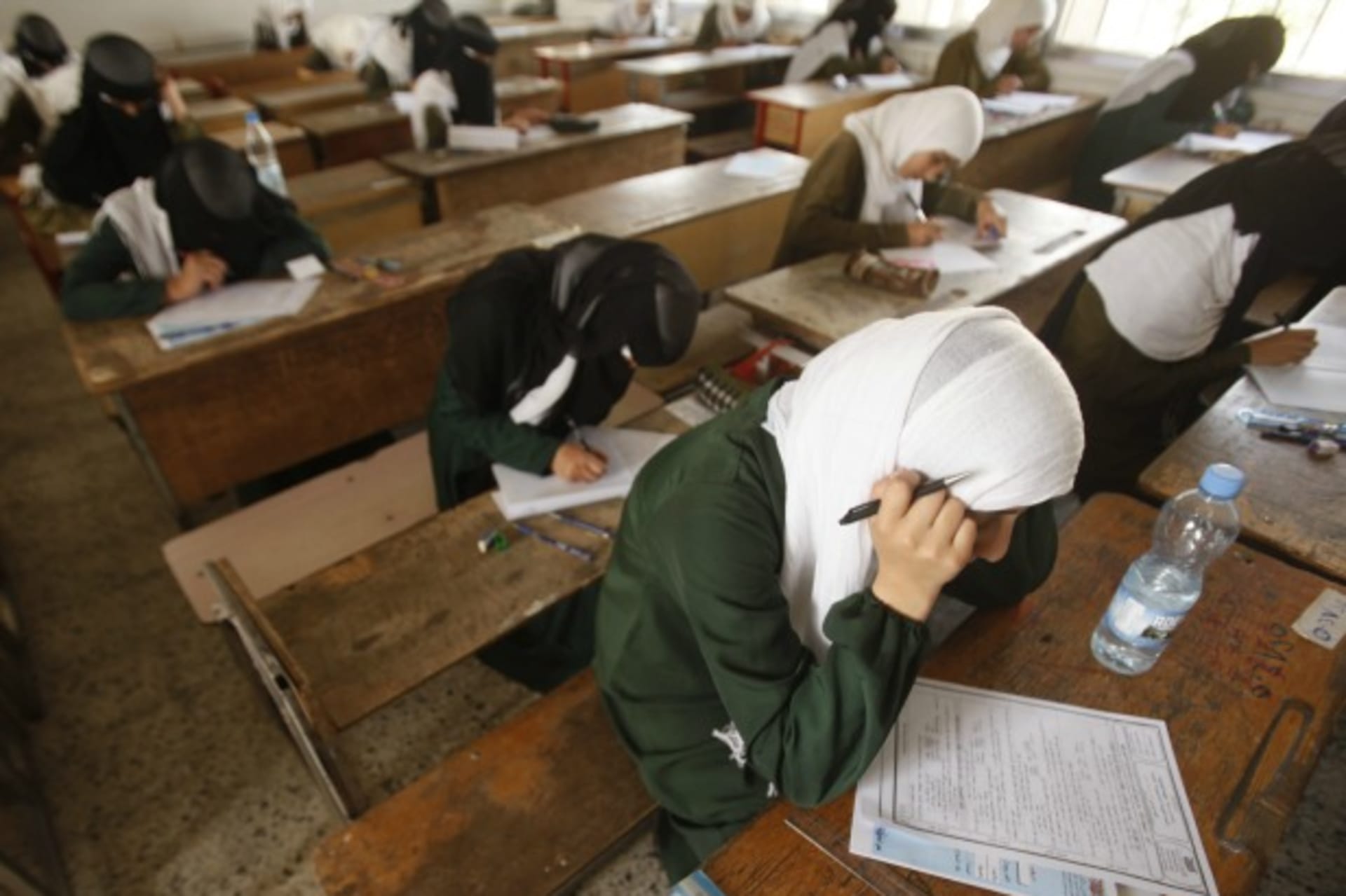 <p>Girls take the final examination of their primary school in Sanaa, Yemen, June 2013 (Courtesy Khaled Abdullah/Reuters).</p>
