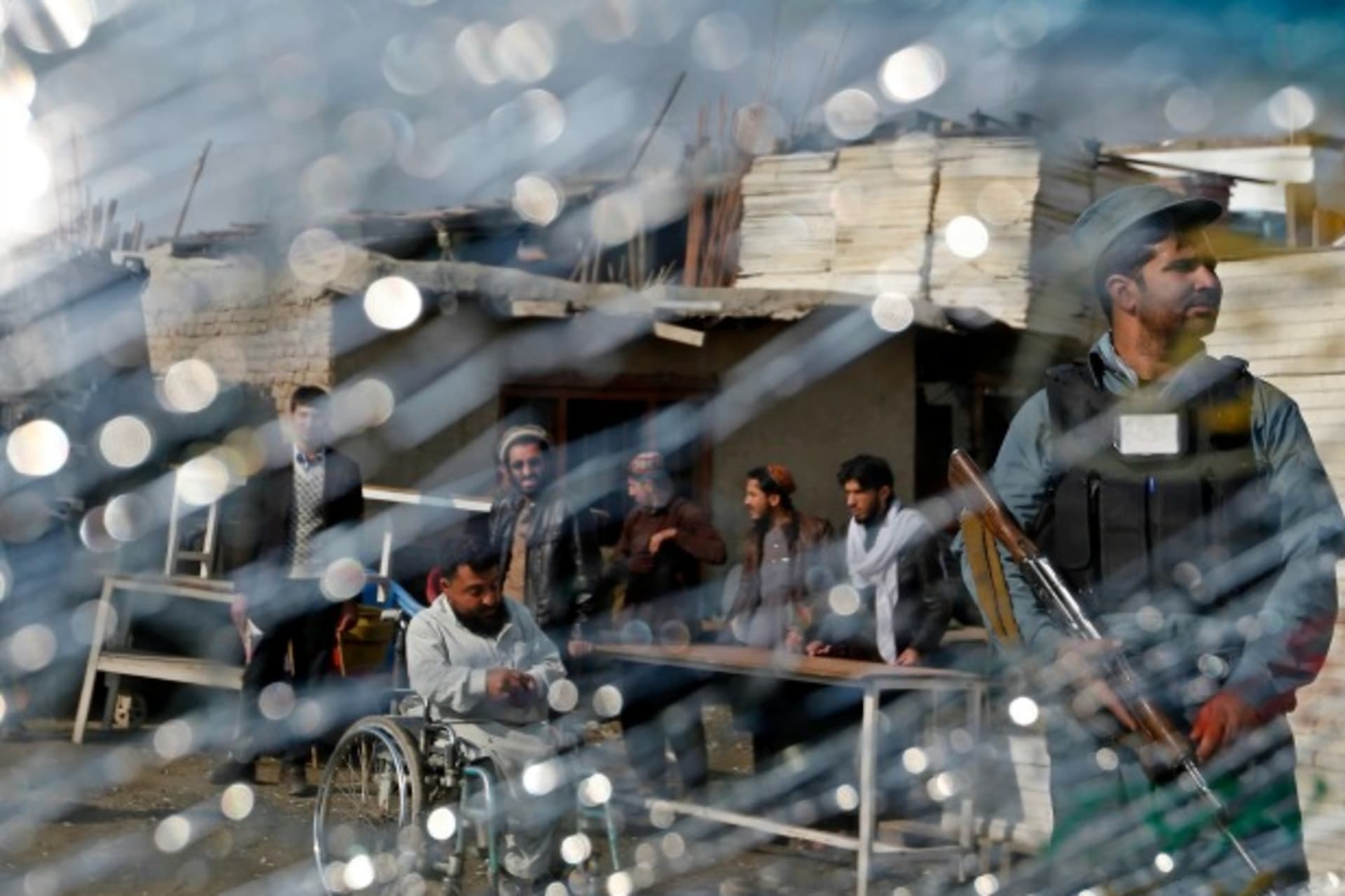 <p>A police officer is seen through the cracked window of a vehicle near the site of a suicide attack in Kabul, Afghanistan, on November 27, 2014 (Courtesy Reuters/Mohammad Ismail).</p>
