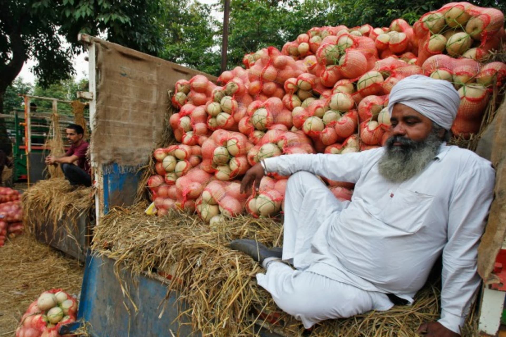 <p>A farmer sits on a trolley loaded with melons as he waits for customers at a fruit and vegetable market in Chandigarh, India, May 2014 (Courtesy Reuters/Ajay Verma).</p>
