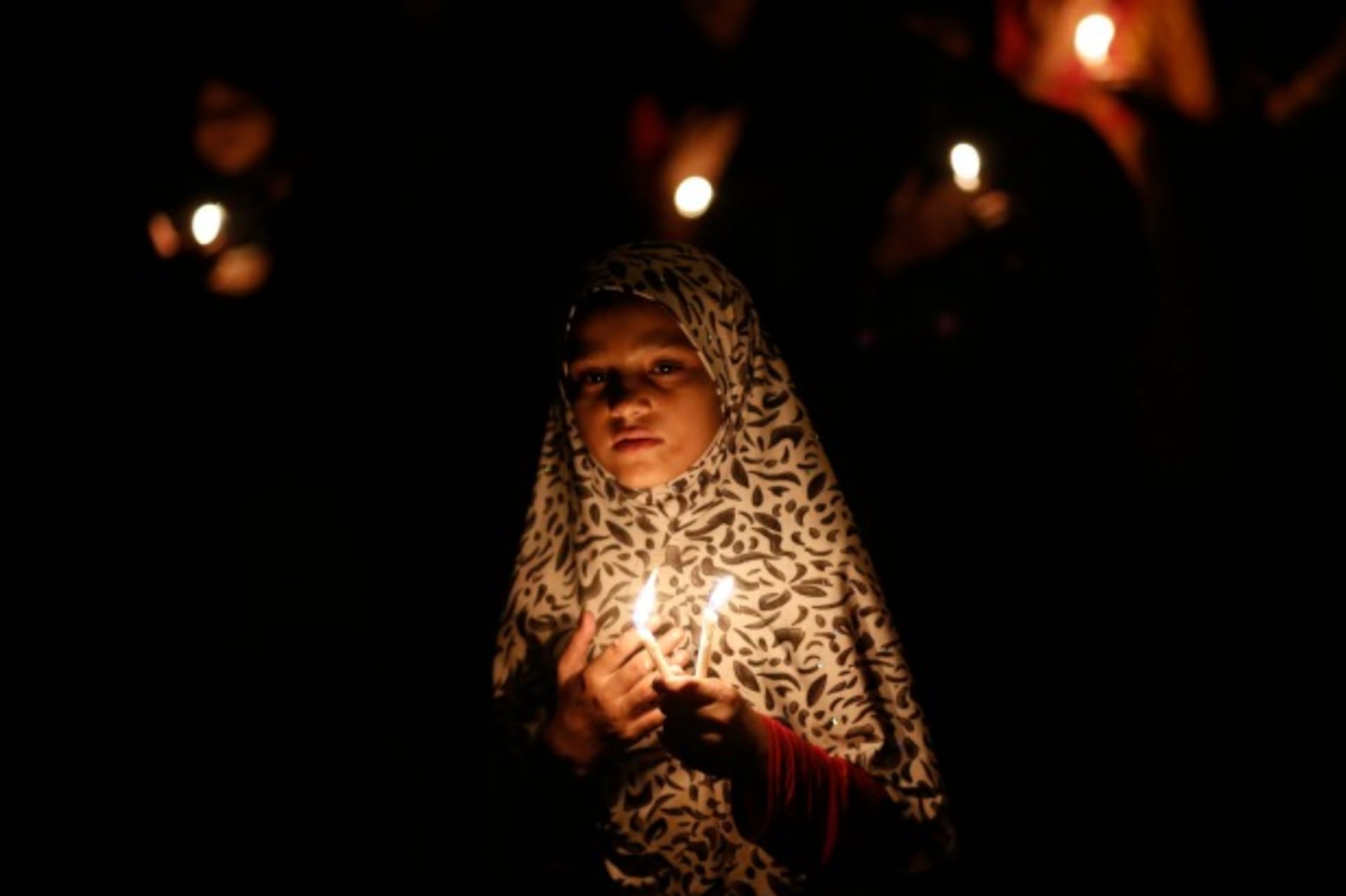 <p>A Shiite Muslim girl takes part in a candlelight protest against the ongoing conflict in Iraq, in New Delhi, India, July 2014 (Courtesy Reuters/Anindito Mukherjee).</p>
