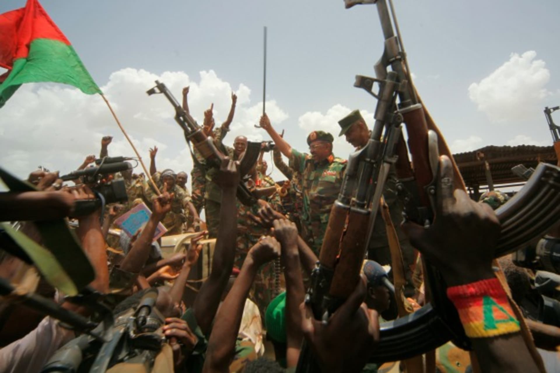 <p>Sudanese President Omar al-Bashir waves at military soldiers in Heglig, Sudan, April 2012 (Courtesy Reuters/Mohamed Nureldin Abdallah).</p>

