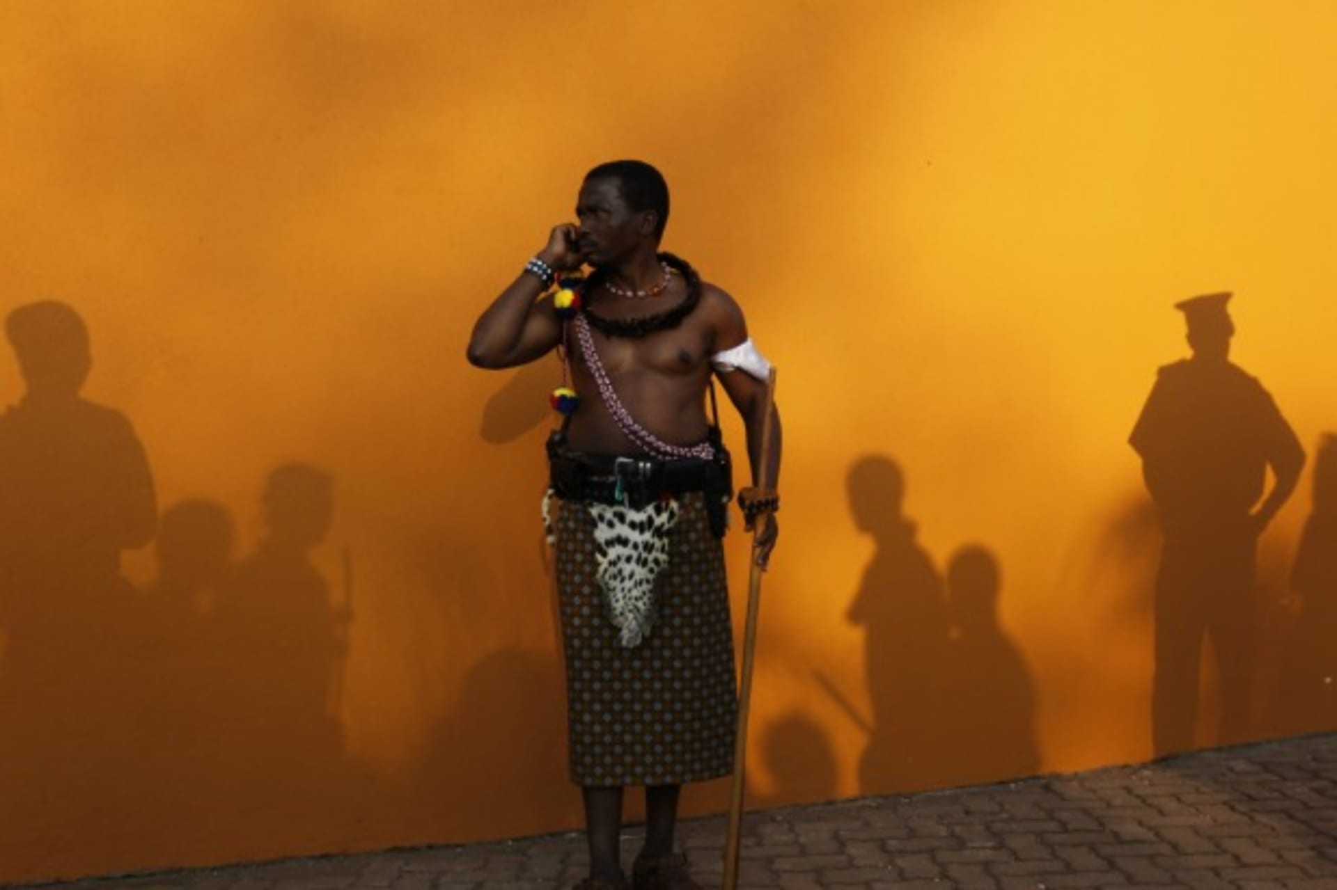 <p>A man dressed in traditional attire speaks on a cell phone in Ludzidzini, Swaziland, August 2010 (Courtesy Reuters/Siphiwe Sibeko).</p>
