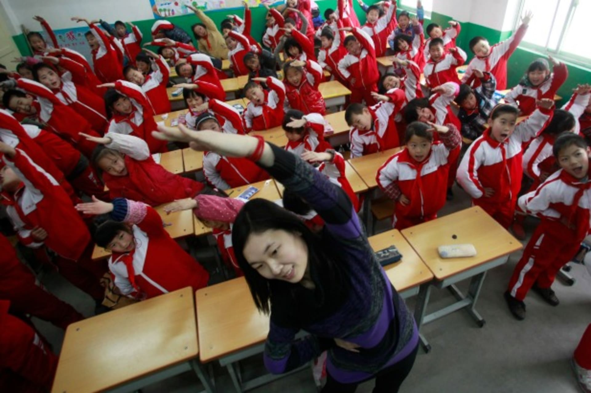 <p>A teacher leads her students in an exercise, Jinan, China, January 2013 (Courtesy Reuters/China Daily).</p>
