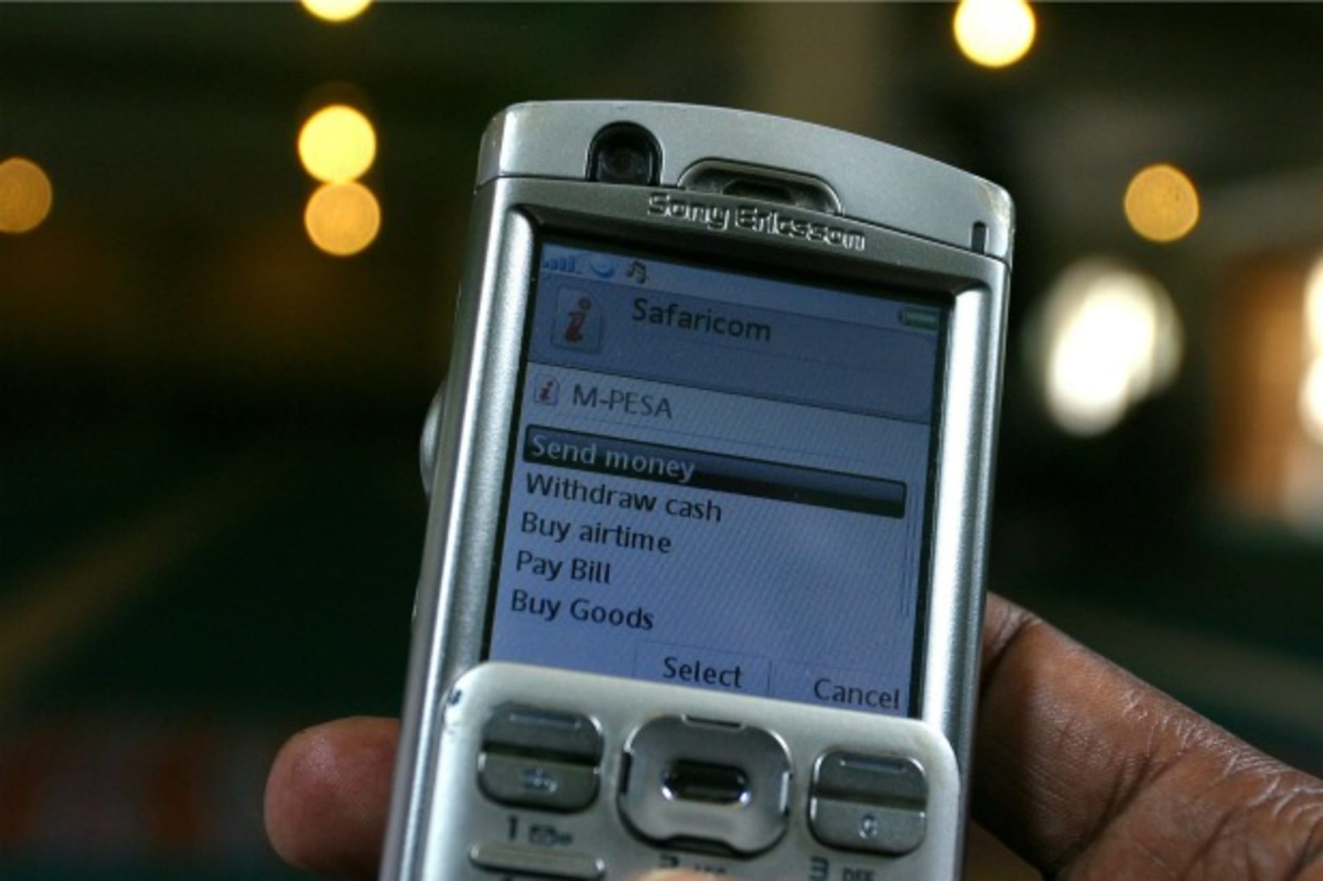 <p>A man uses the M-PESA mobile banking system in Nairobi, Kenya, May 2009 (Courtesy Reuters/Noor Khamis).</p>
