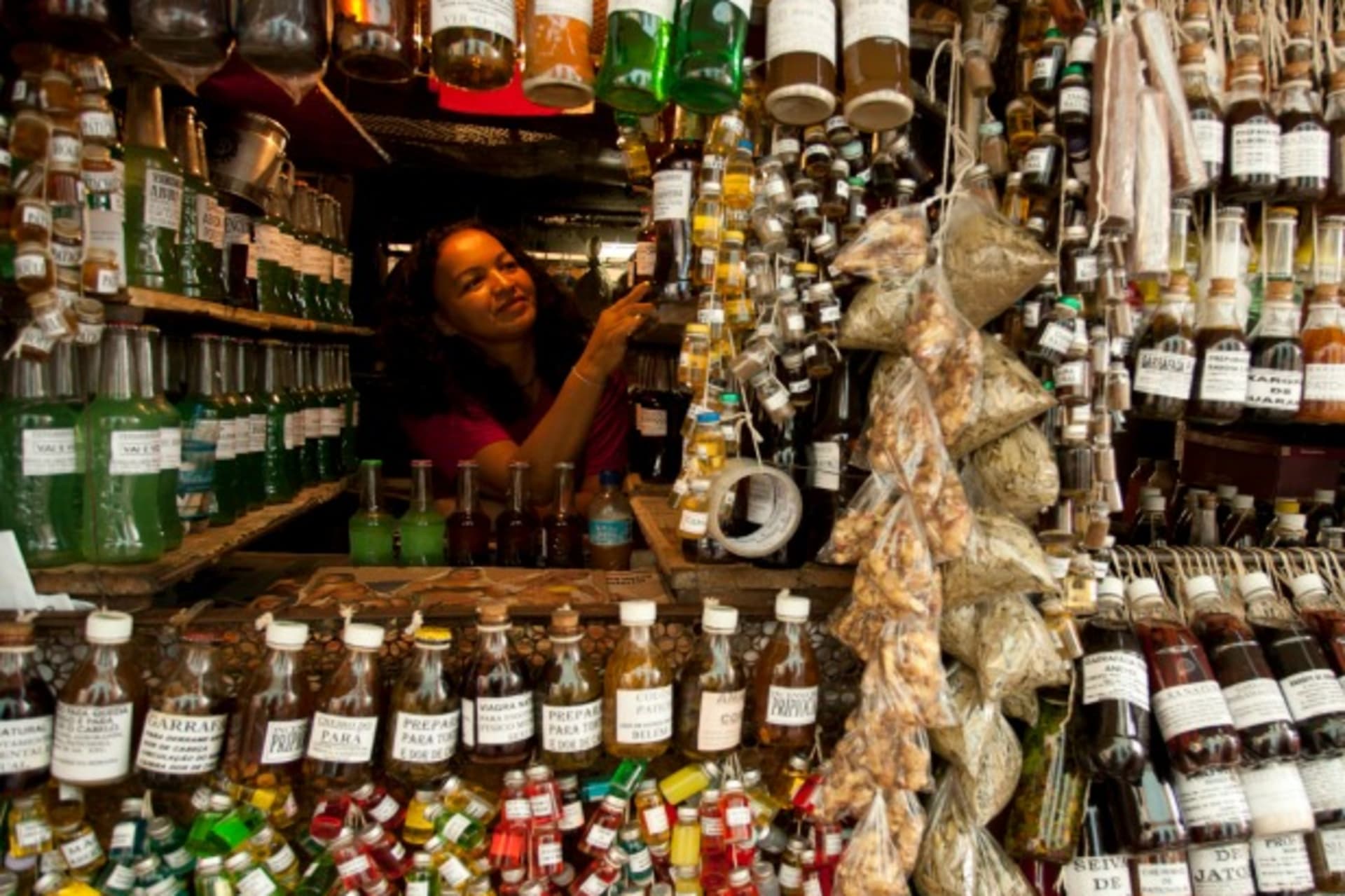 <p>A shopkeeper arranges her bottles of perfumes and oil in Belem, Brazil, January 2011 (Courtesy Reuters/Paulo Santos).</p>

