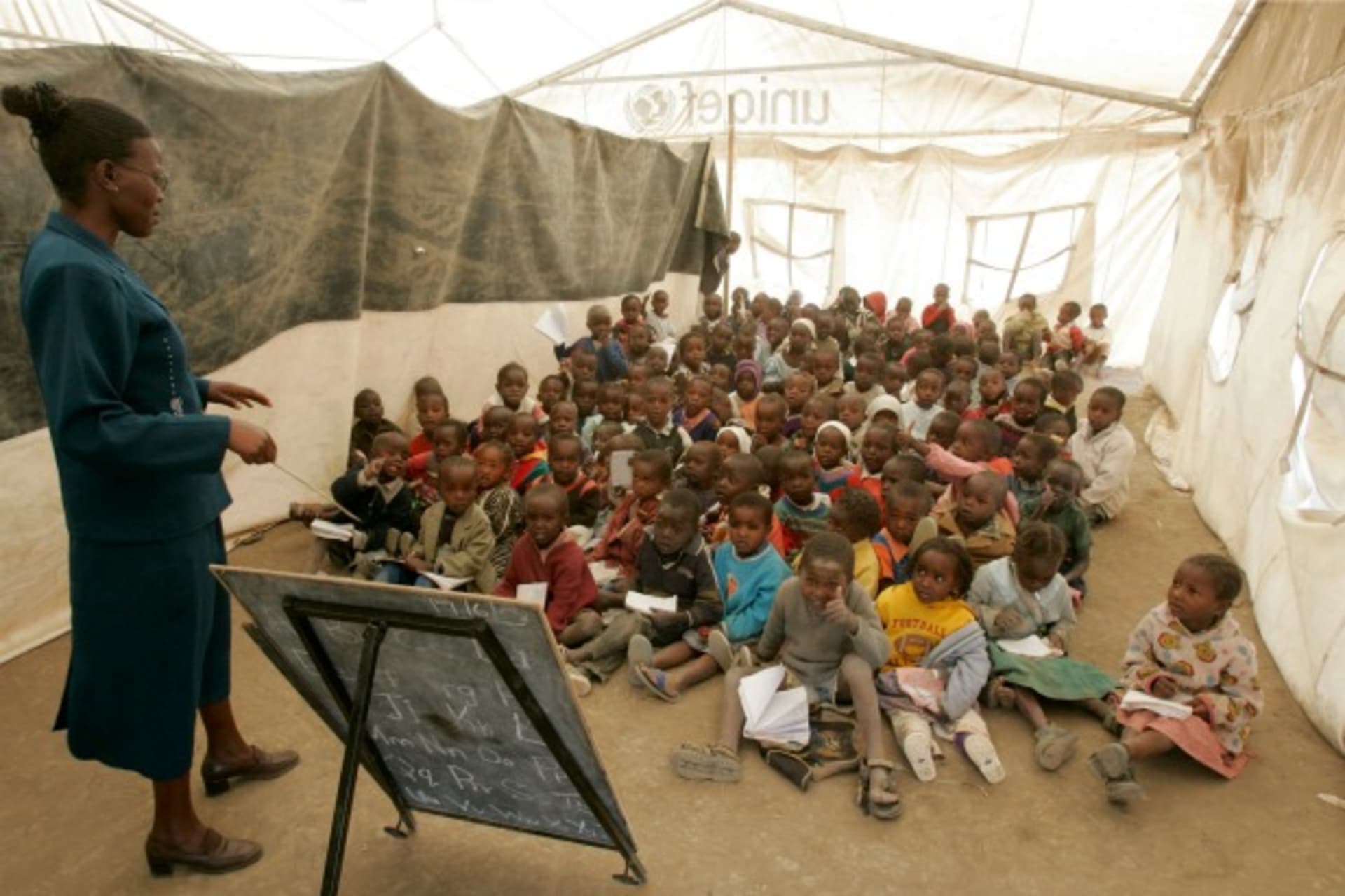 <p>Children listen to their teacher during a lesson at a camp for internally displaced people in Naivasha, Kenya, June 2008 (Courtesy Reuters/Antony Njuguna).</p>
