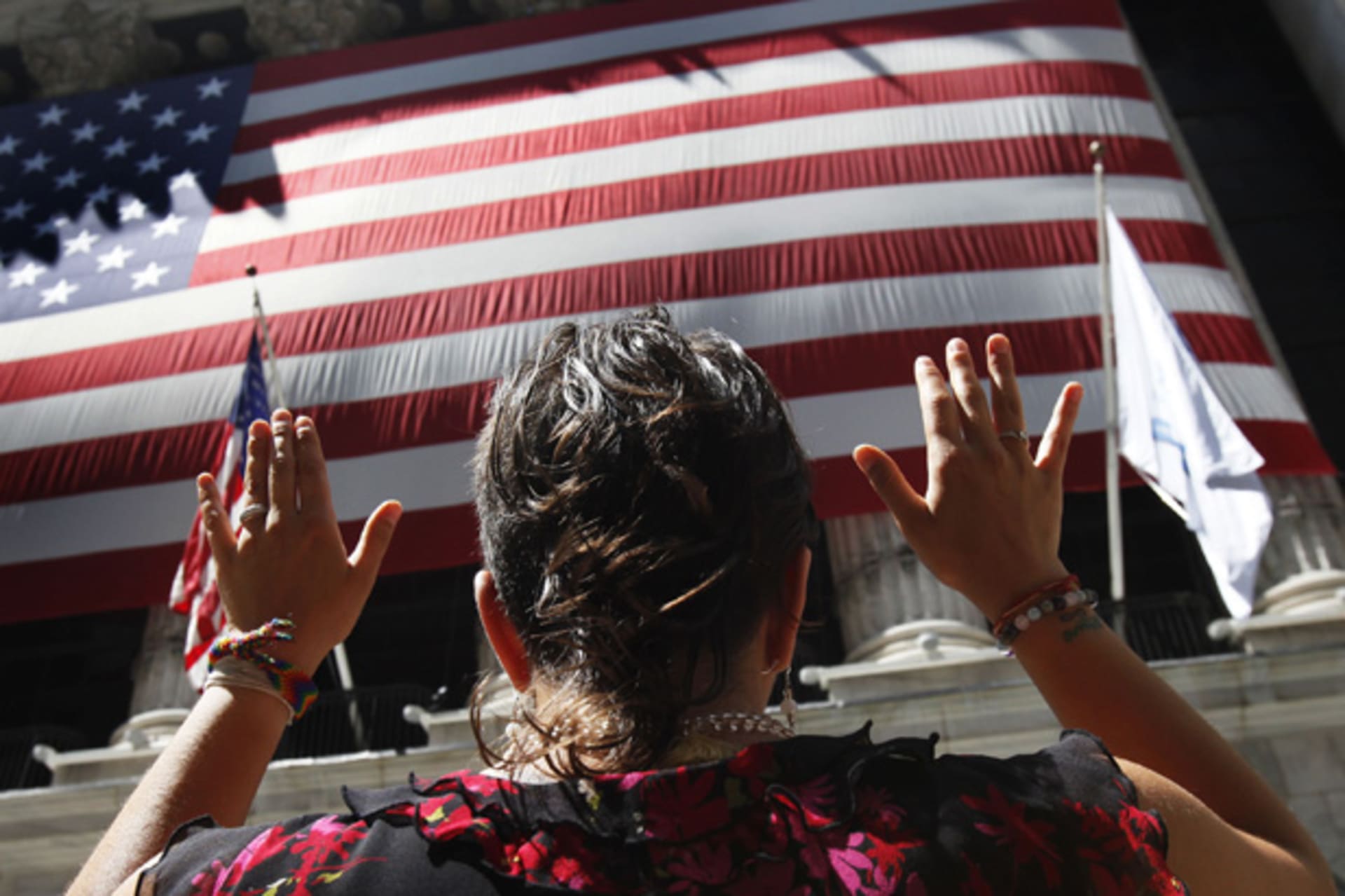 <p>A woman is seen outside the New York Stock Exchange (Shannon Stapleton/Courtesy Reuters).</p>
