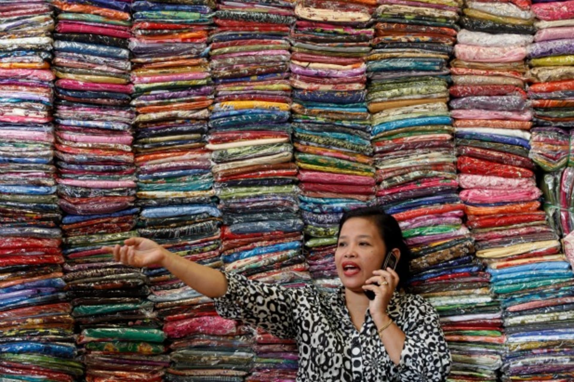 <p>Fadhilah Arshad, a Malaysian businesswoman, talks to a supplier as she sells cloth at her bazaar in Kuala Lumpur, December 2009. (Courtesy Reuters/Bazuki Muhammad).</p>
