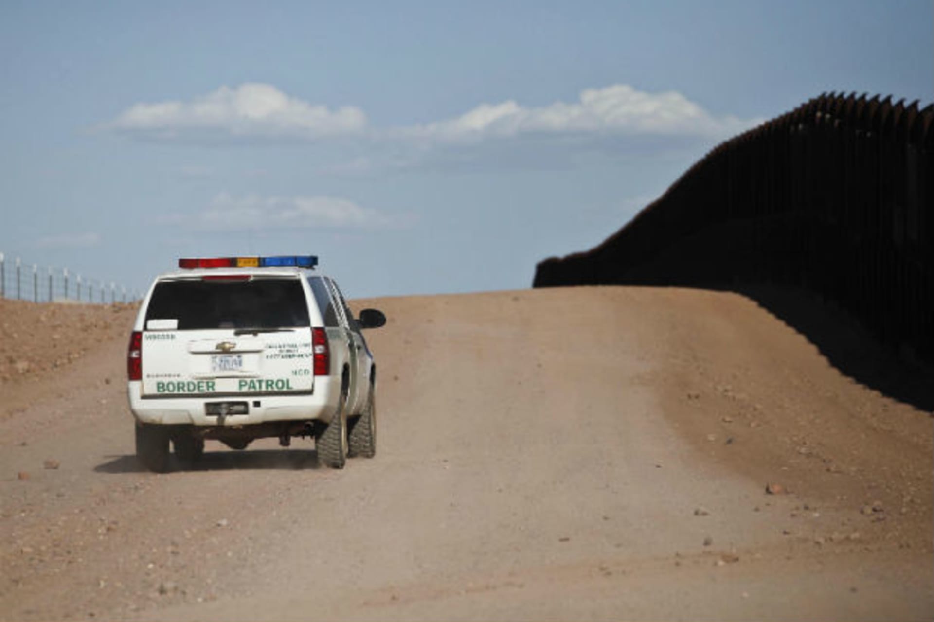<p>U.S. Border Patrol surveys the border fence near rancher John Ladd’s property adjacent to the Arizona-Mexico border near Naco, Arizona, March 29, 2013.</p>
