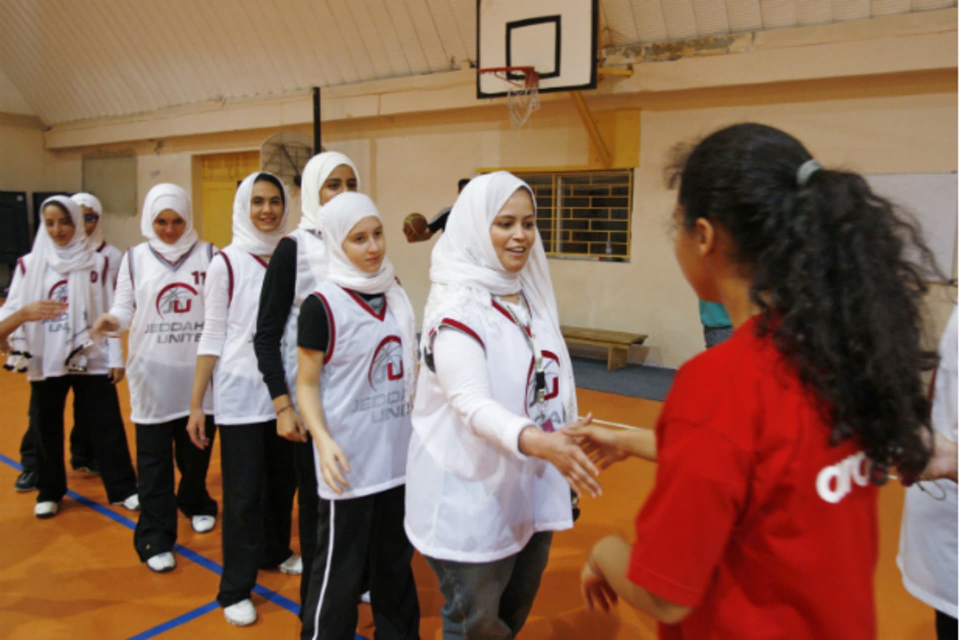 <p>Saudi Arabia’s Jeddah United (in white) shake hands with Jordan’s Al Reyadeh before their friendly basketball game in Amman on April 21, 2009 (Ali Jarekji/Courtesy Reuters).</p>

