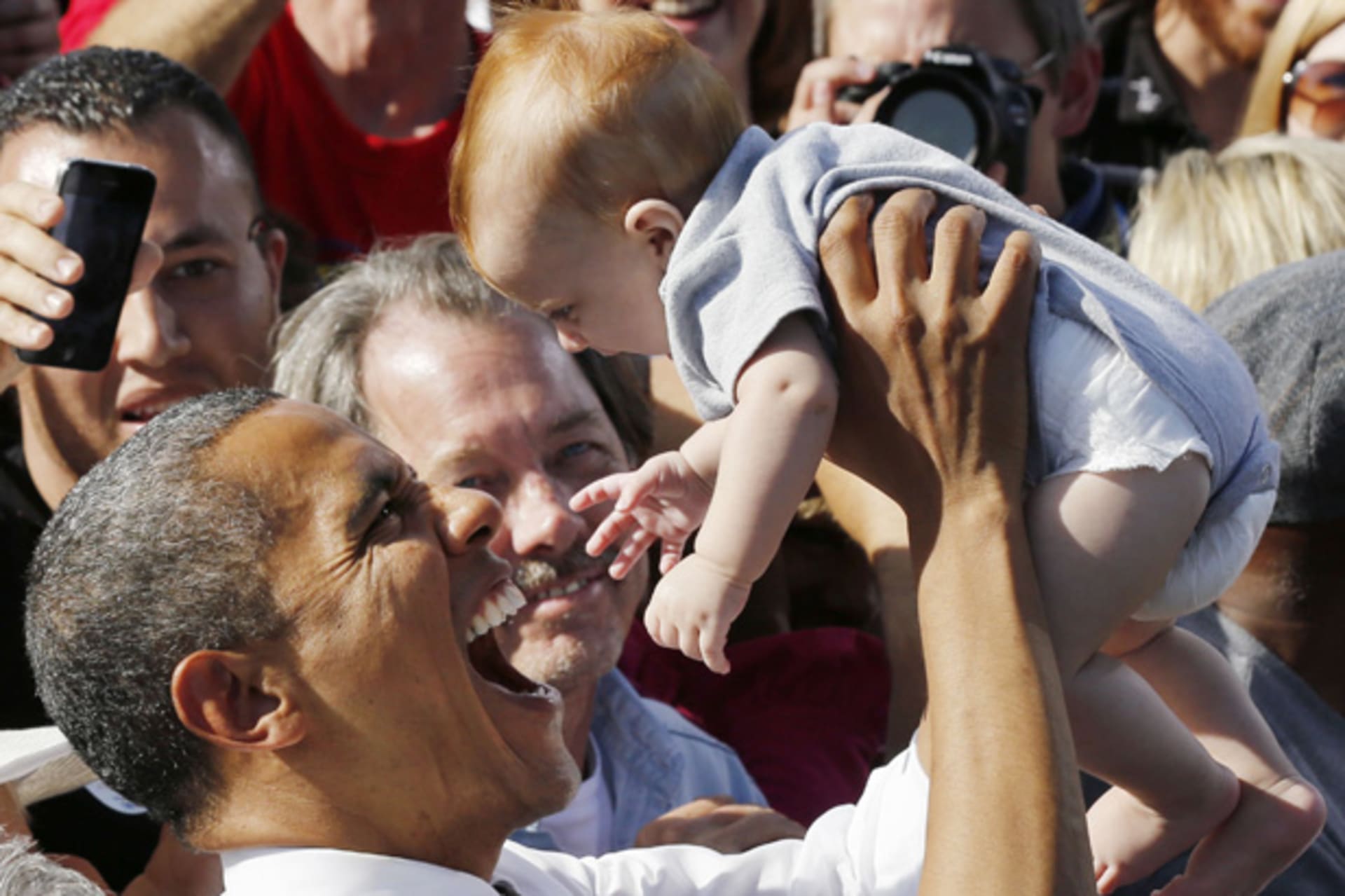 <p>President Obama holds up a baby after speaking in Las Vegas (Larry Downing/Courtesy Reuters).</p>
