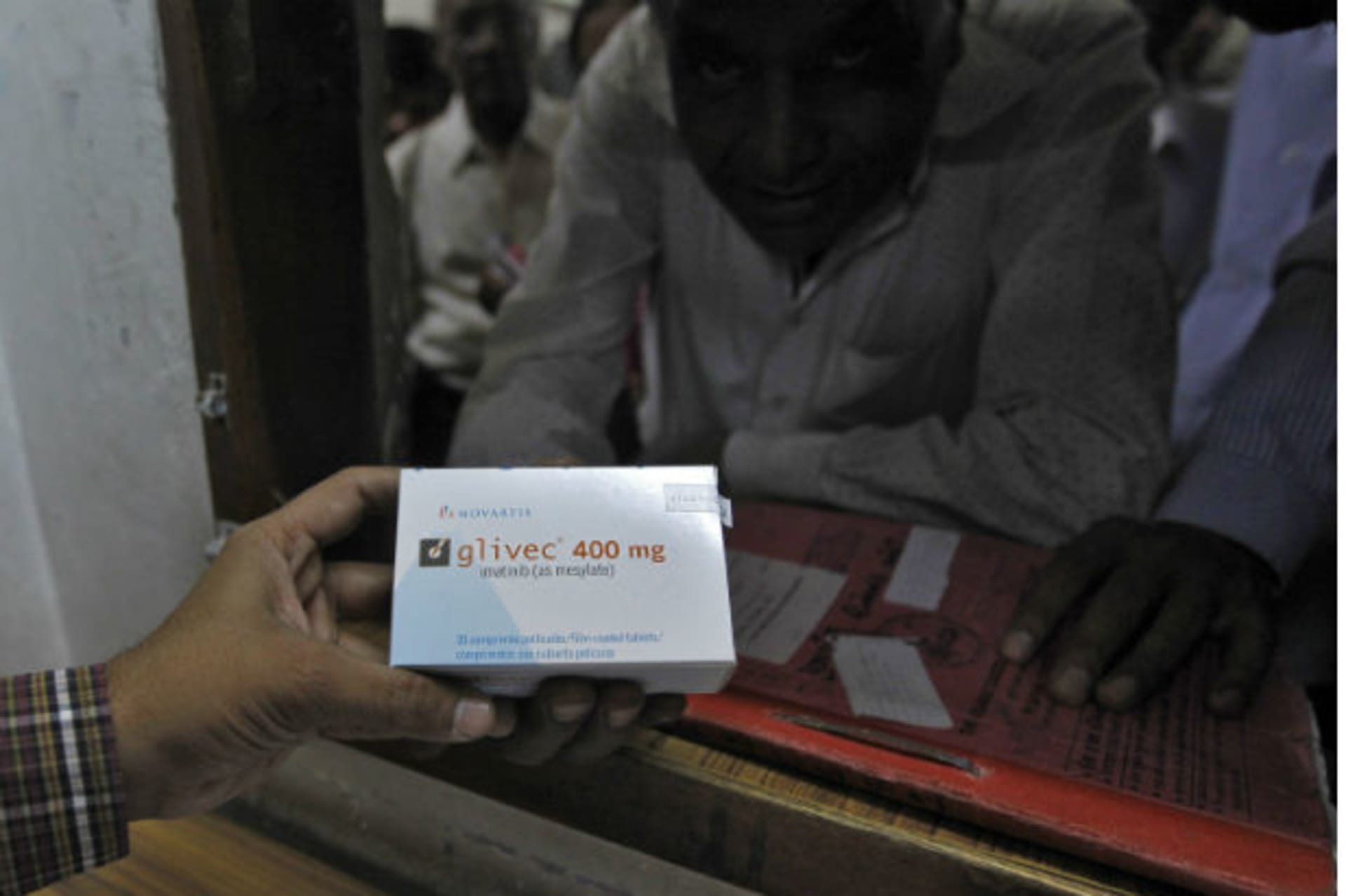 <p>A man buys cancer drug Glivec for a relative who is suffering from cancer at a pharmacy in a government-run hospital in the western Indian city of Ahmedabad on April 2, 2013 (Amit Dave/Courtesy Reuters).</p>
