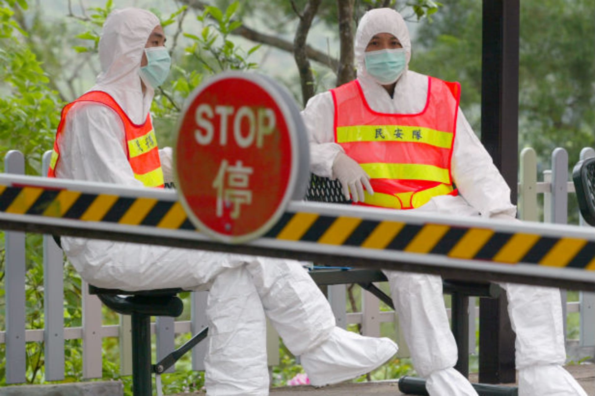 <p>Security officers in protective suits, to prevent themselves from catching the pneumonia-like Severe Acute Respiratory Syndrom…ome 200 of the more than 400 residents evacuated from Amoy Gardens in Hong Kong on April 2, 2003 (Bobby Yip/Courtesy Reuters).</p>
