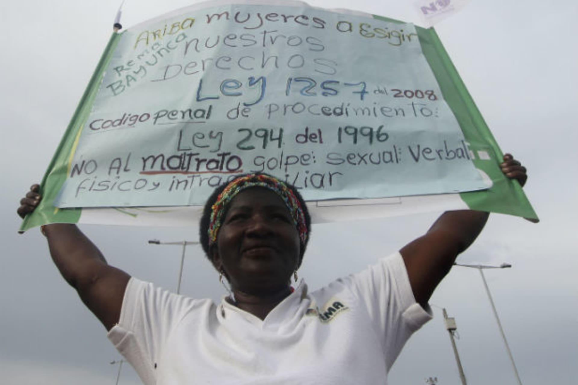 <p>A woman holds a banner during a protest against all forms of violence calling for respect for the rights of women, in Cartagena, Colombia on July 5, 2012 (Joaquin Sarimento/Courtesy Reuters).</p>
