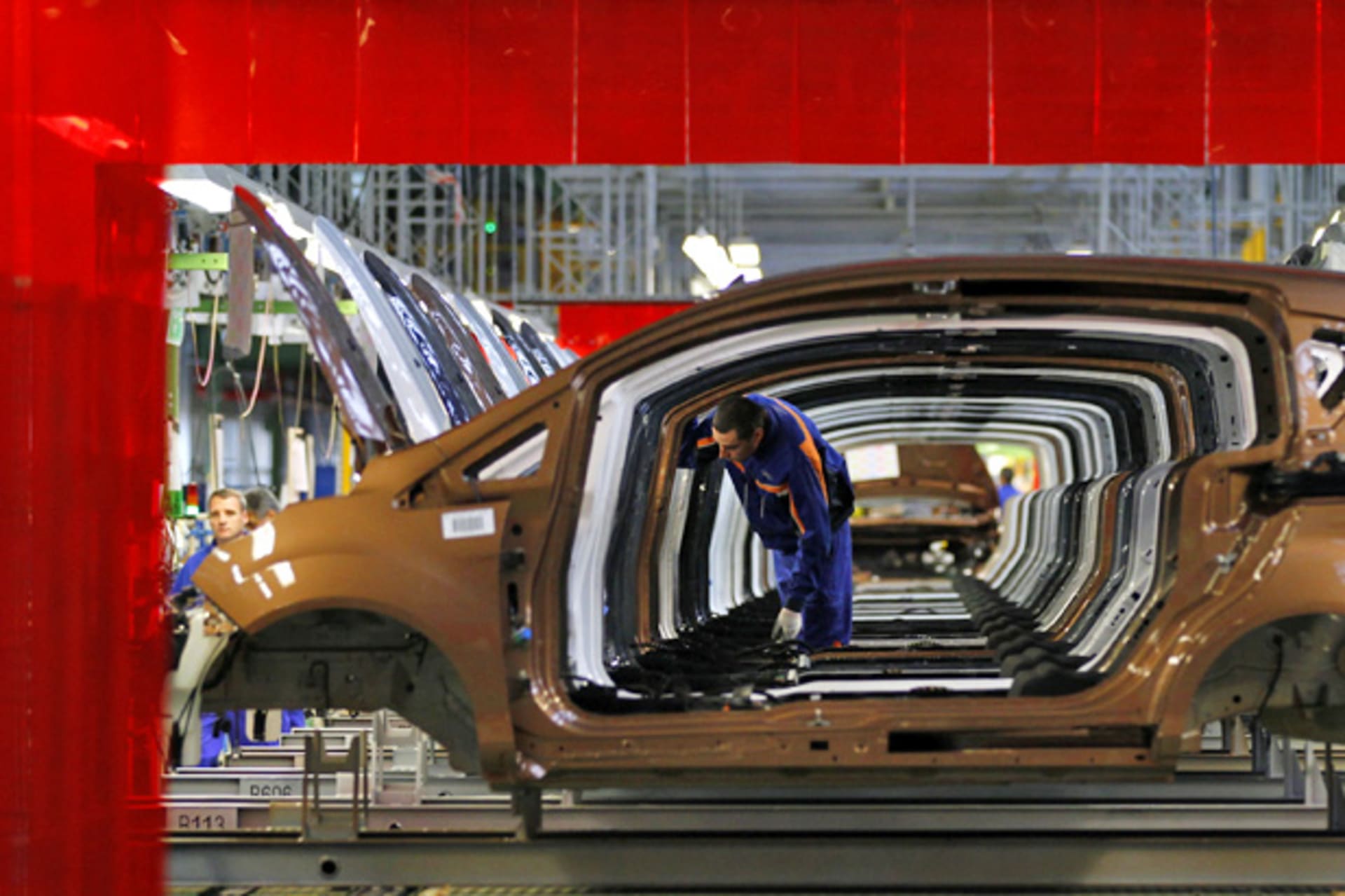 <p>A worker checks vehicles at a Ford car plant in Craiova, Romania (Bogdan Cristel/Courtesy Reuters).</p>
