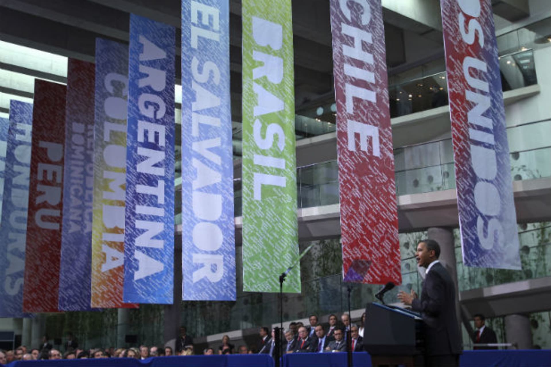 <p>U.S. President Obama delivers a speech in front of banners representing Latin American nations in Santiago</p>
