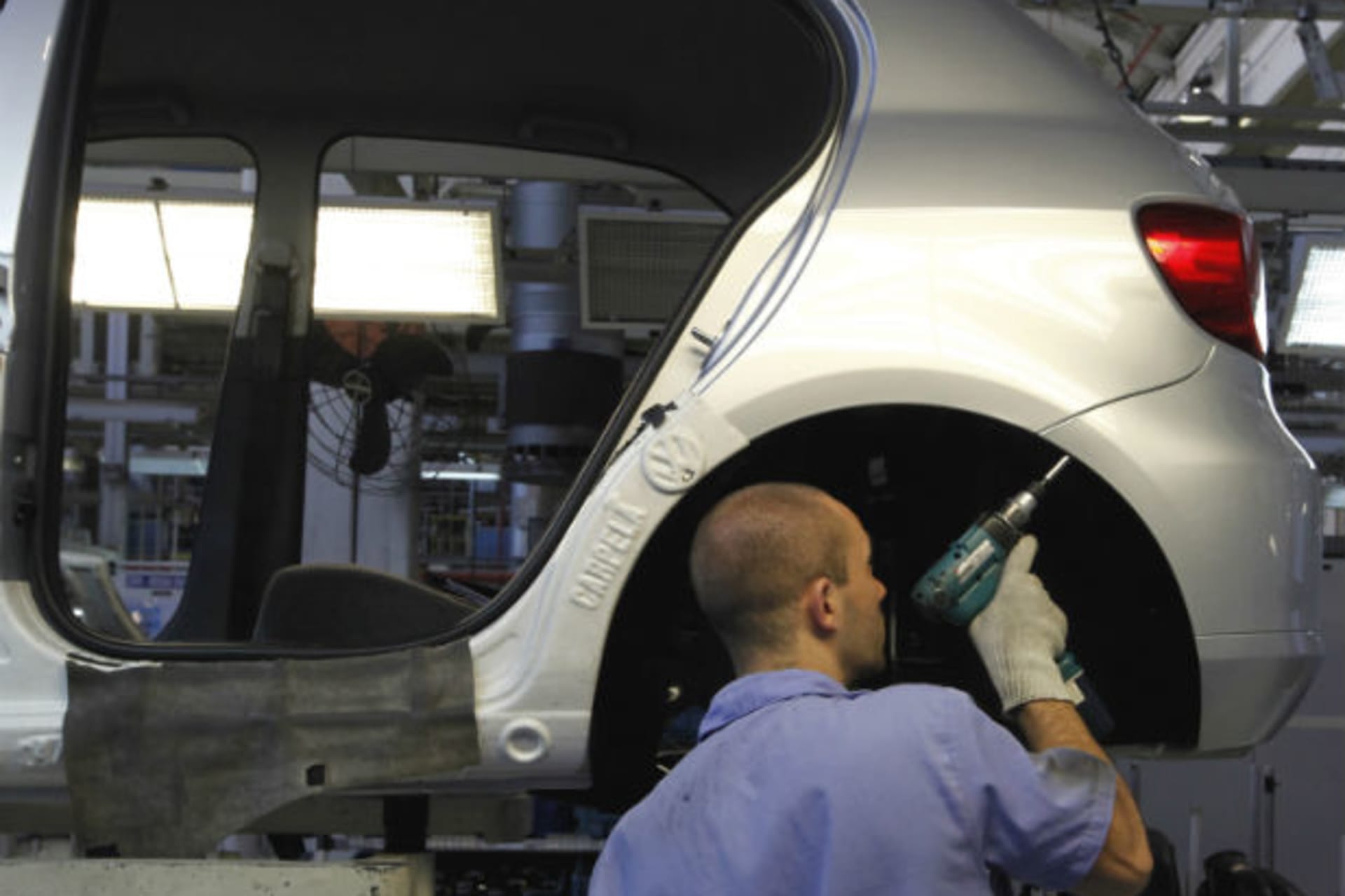 <p>Brazilian worker assembles a Volkswagen car at Sao Bernardo do Campo Volkswagen plant, near Sao Paulo (Nacho Doce/Courtesy Reuters).</p>

