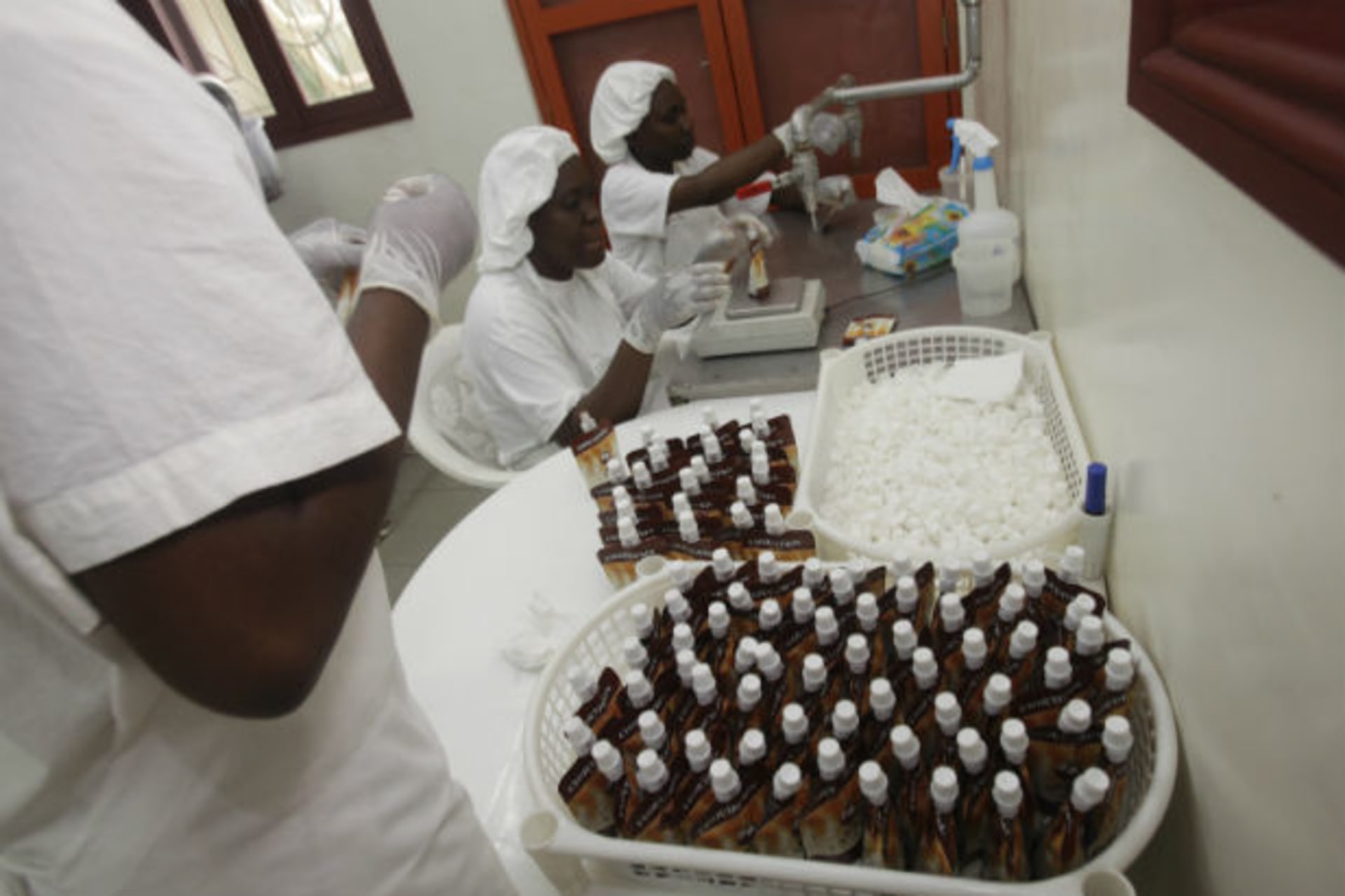 <p>Employees work at a cocoa micro-manufacturing plant owned by Olga Yenou, an Ivorian woman, in Abidjan on November 29, 2011 (Thierry Gouegnon/Courtesy Reuters).</p>
