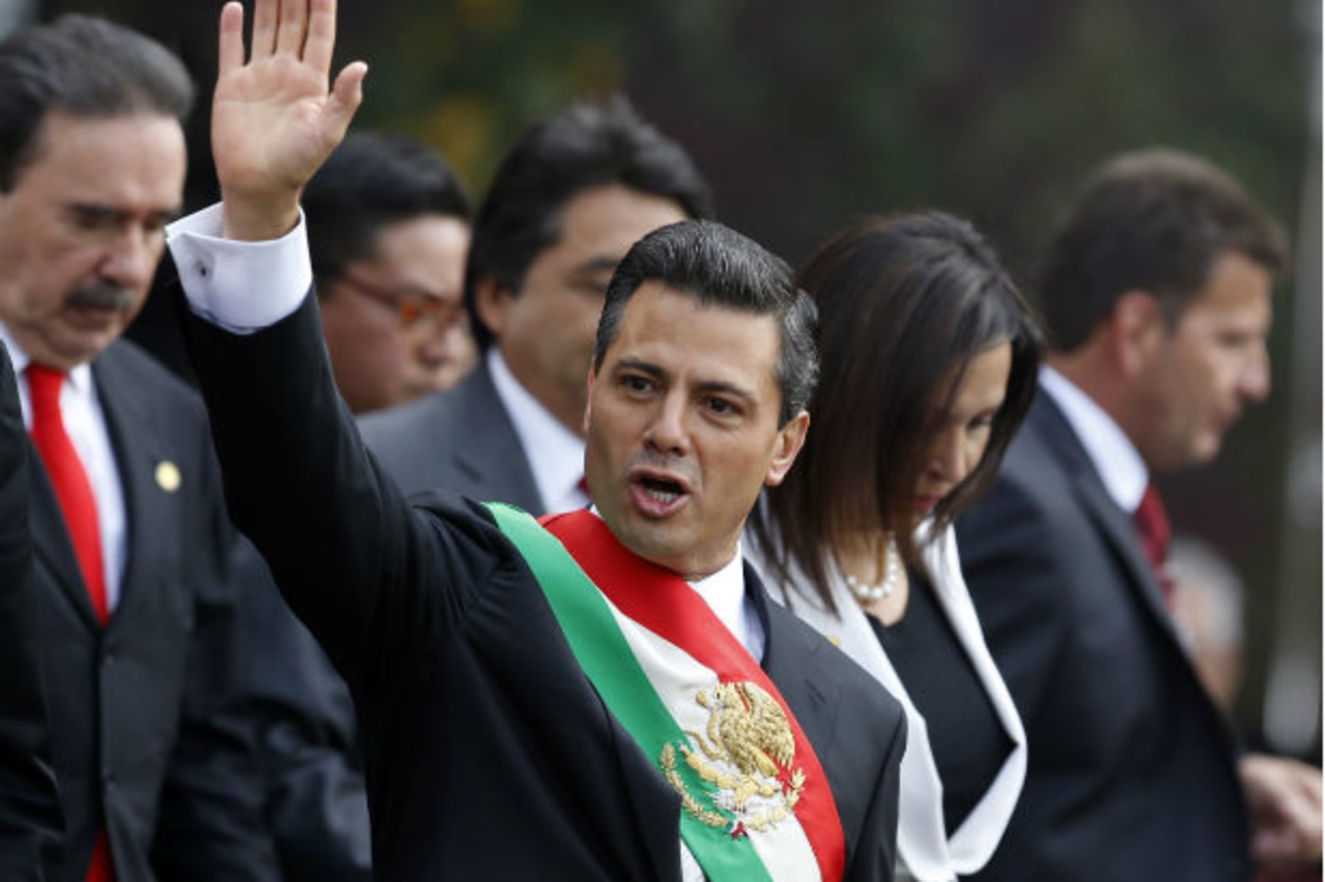 <p>Mexico’s new President Enrique Pena Nieto waves after taking oath in congress in Mexico City (Stringer/Courtesy of Reuters).</p>
