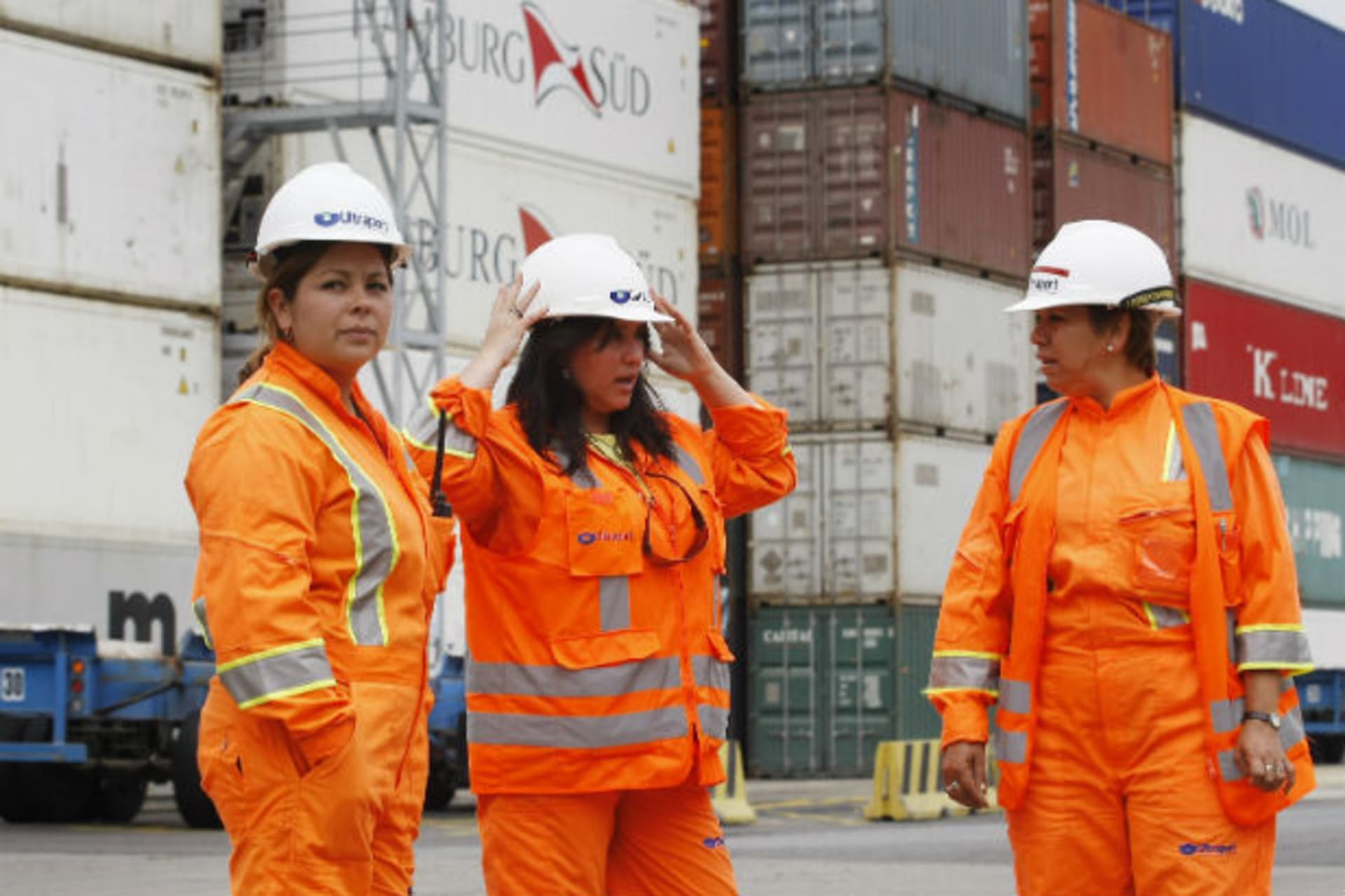 <p>Female dock workers talk and prepare for their shifts at the port of Valparaiso city (Eliseo Fernandez/Courtesy Reuters).</p>
