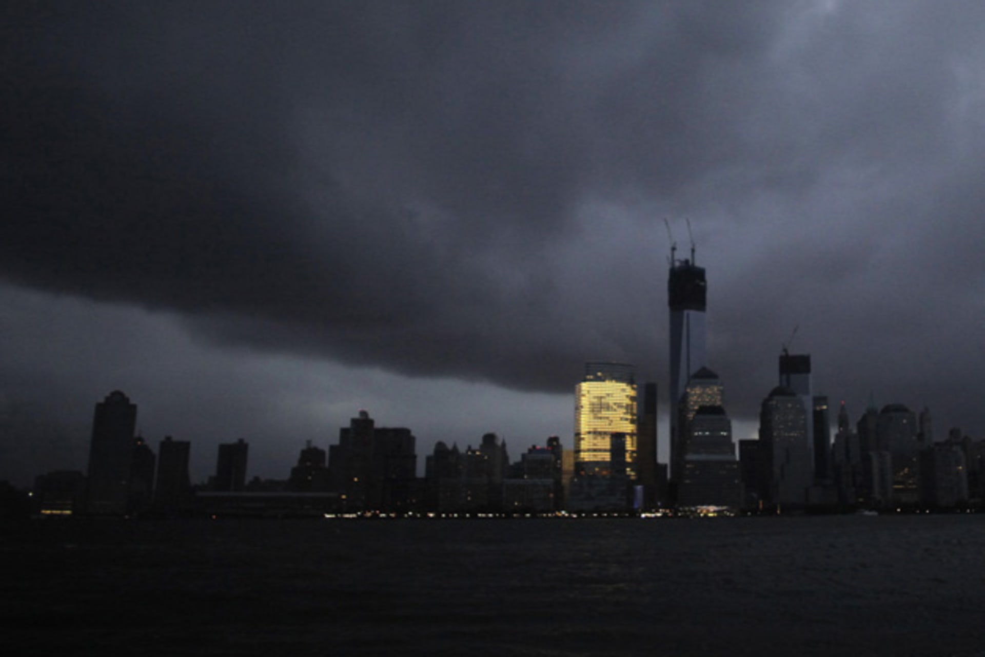 <p>The skyline of lower Manhattan is seen mostly in darkness, except for the Goldman Sachs building, after a preventive power outage caused by Hurricane Sandy on October 30, 2012 (Eduardo Munoz/Courtesy Reuters).</p>
