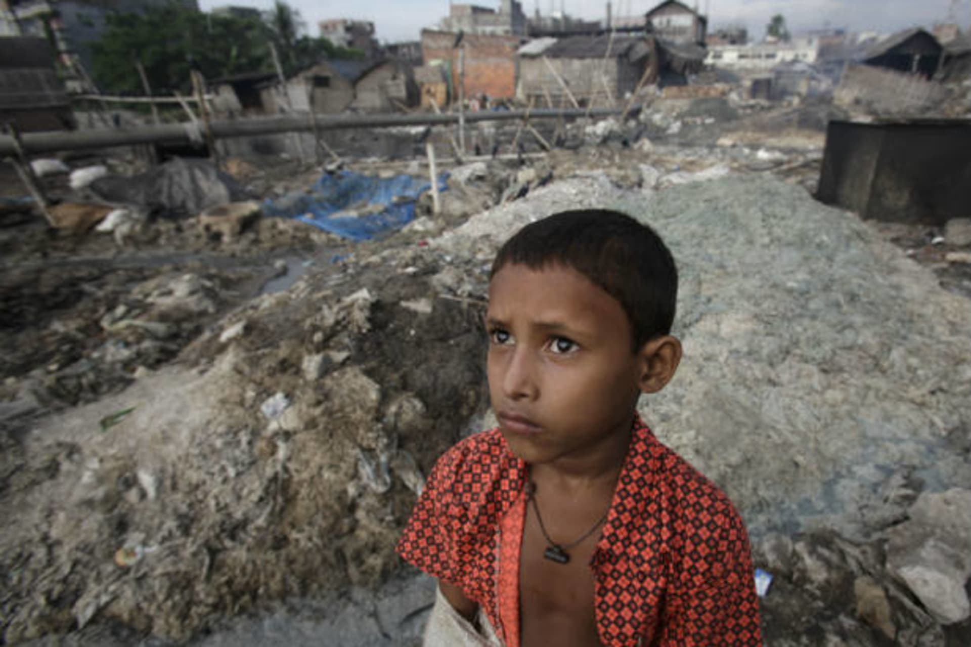 <p>A boy stands in front of the tannery wastes at Hazaribagh in Dhaka, Bangladesh on October 9, 2012 (Andrew Biraj/Courtesy Reuters).</p>
