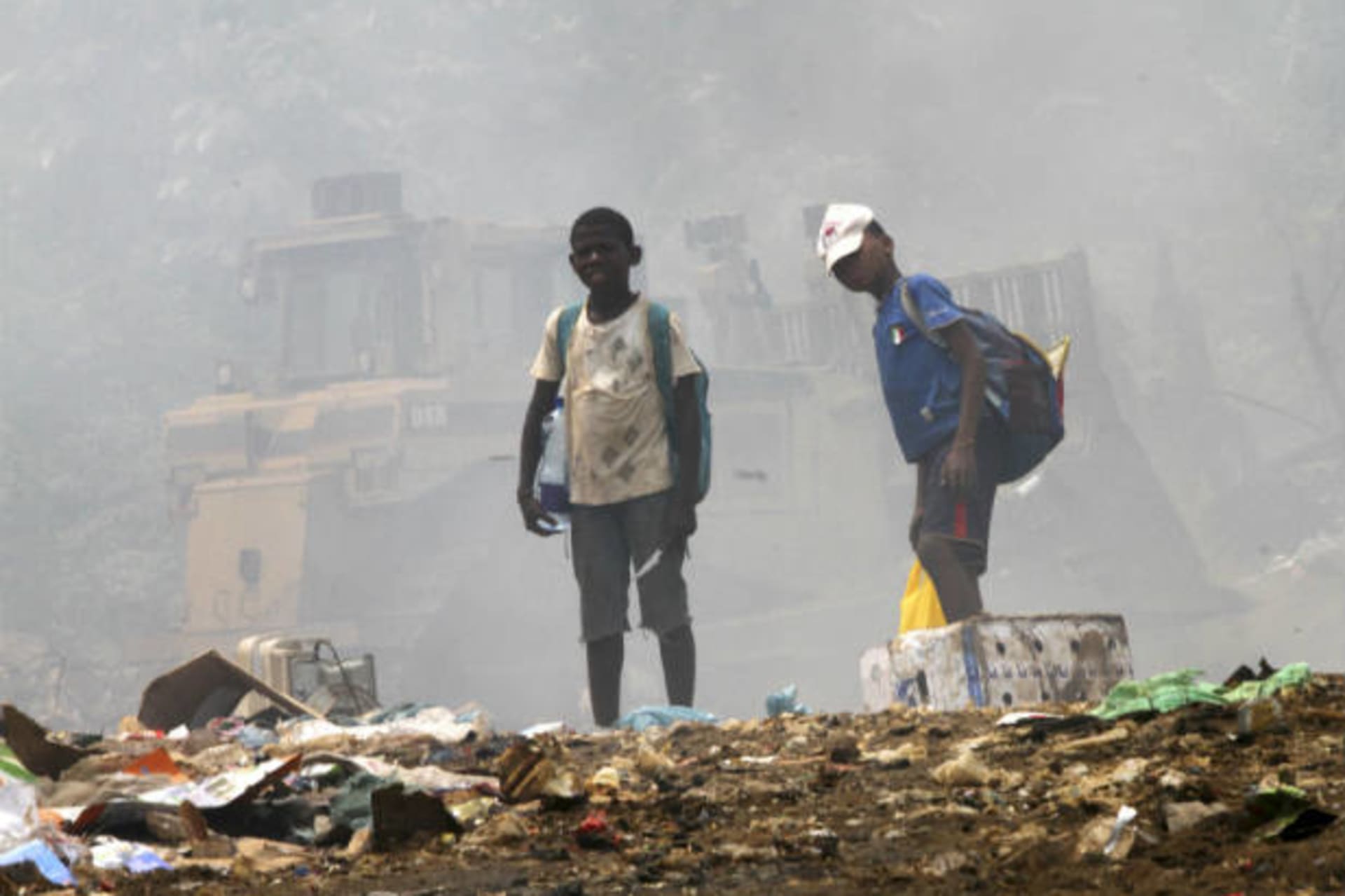 <p>Children stand on garbage as they scavenge at a public dump in Malabo, Equatorial Guinea on January 28, 2012 (Luc Gnago/Courtesy Reuters).</p>
