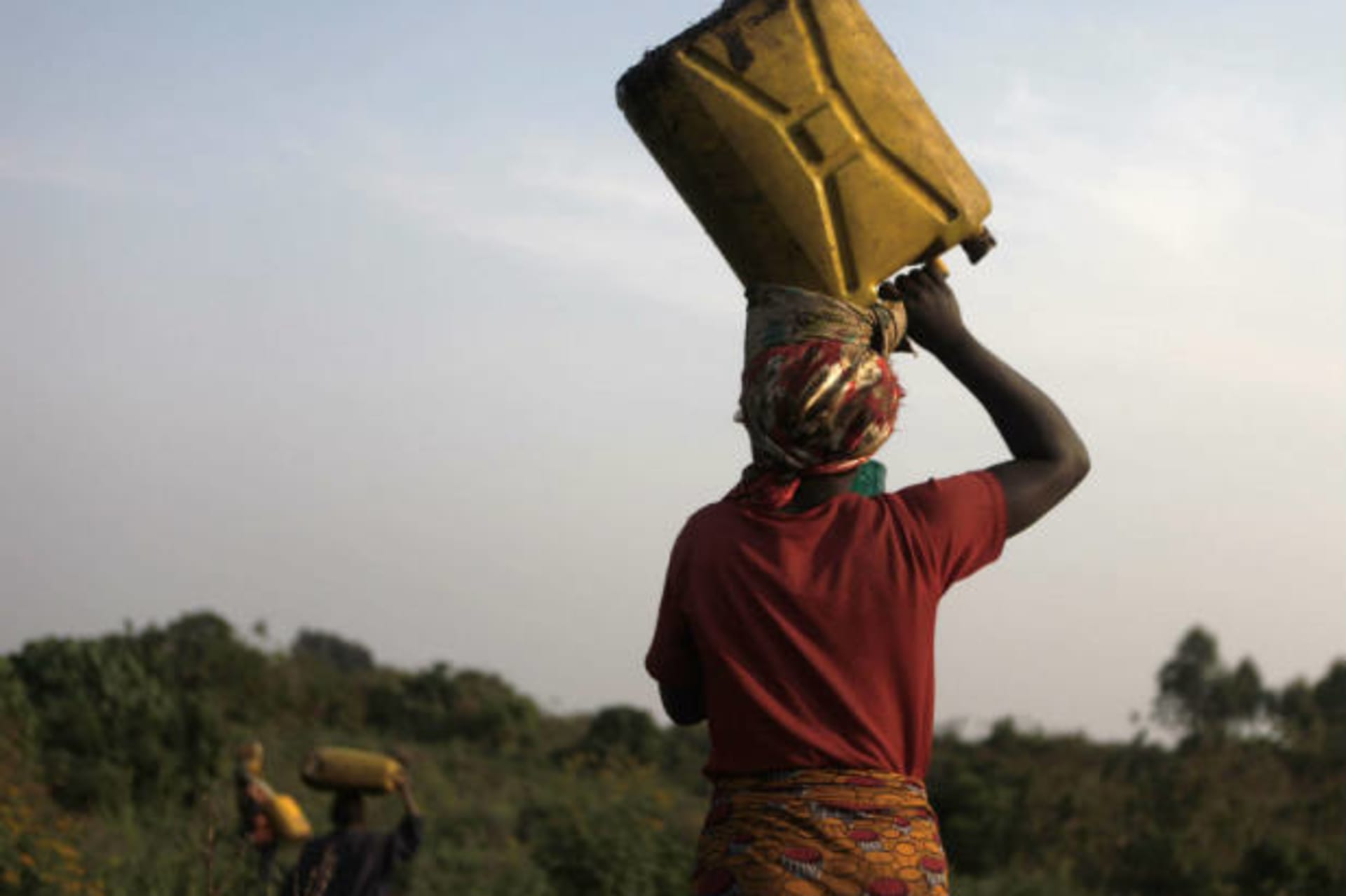 <p>Dusabe Munyarugamba, 16, carries a container of water on her head at Bukima, just north of the eastern Congolese city of Goma,…ters into a cave using burning shoots of grass to light their way into the muddy darkness (Finbarr O’Reilly/Courtesy Reuters).</p>
