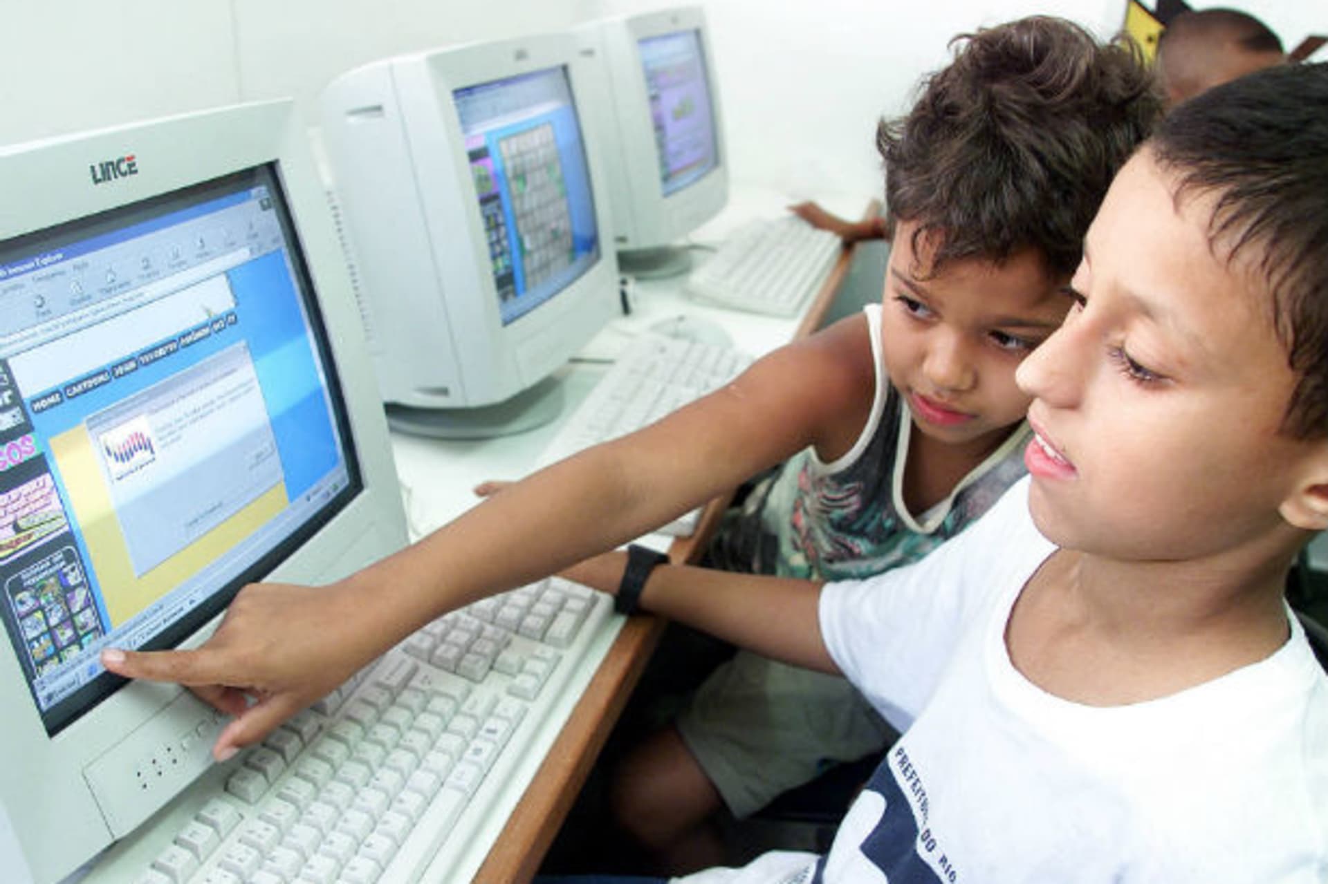 <p>Brazilian children Alexandre da Costa (L) and Augusto Ribeiro use a computer at Mare slum in Rio de Janeiro (Sergio Moraes/Courtesy Reuters).</p>
