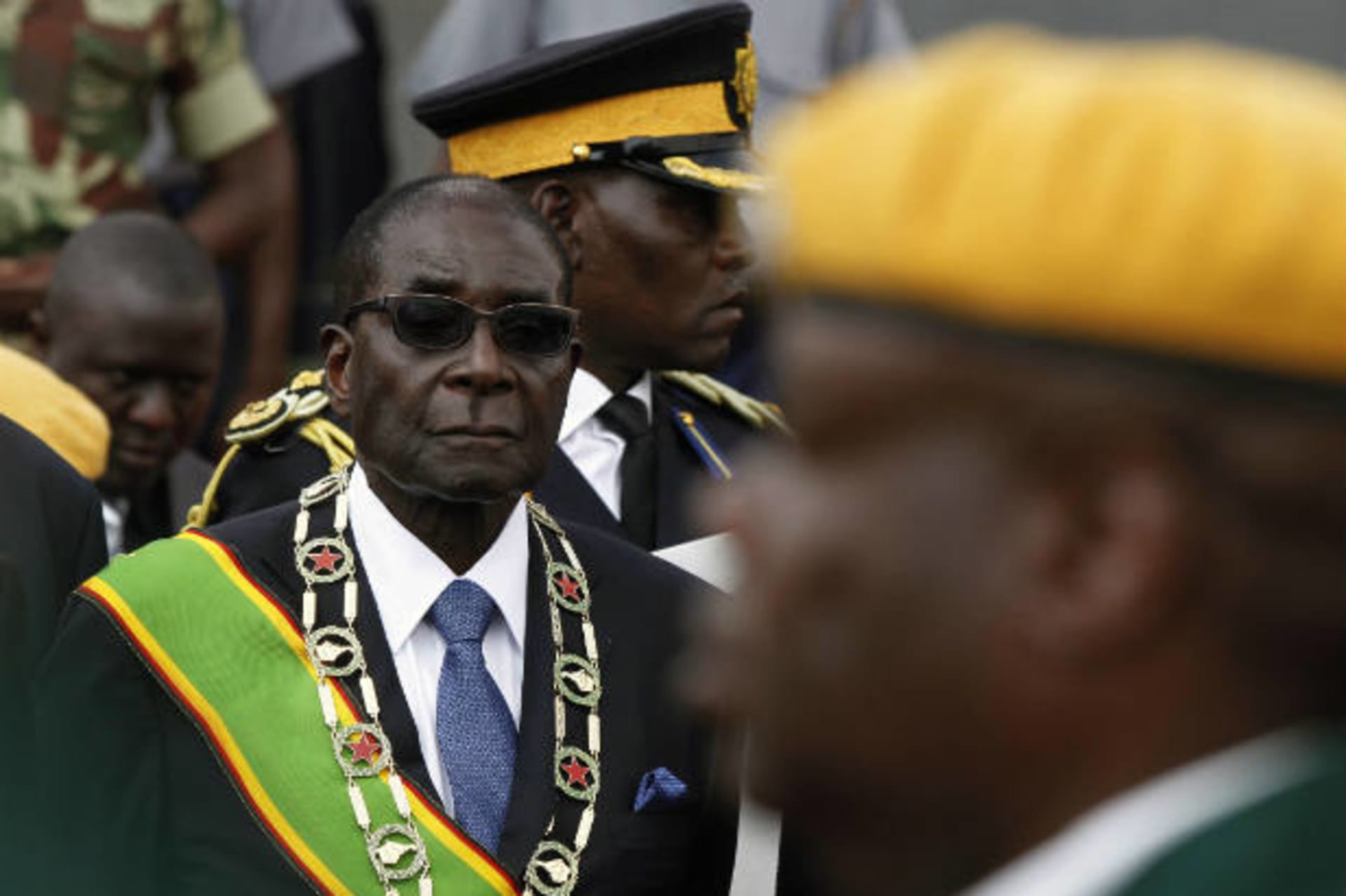 <p>President of Zimbabwe Robert Mugabe (L) attends a commemorative event for National Heroes’ Day at the National Heroes Acre in Harare on August 13, 2012 (Philimon Bulawayo/Courtesy Reuters).</p>
