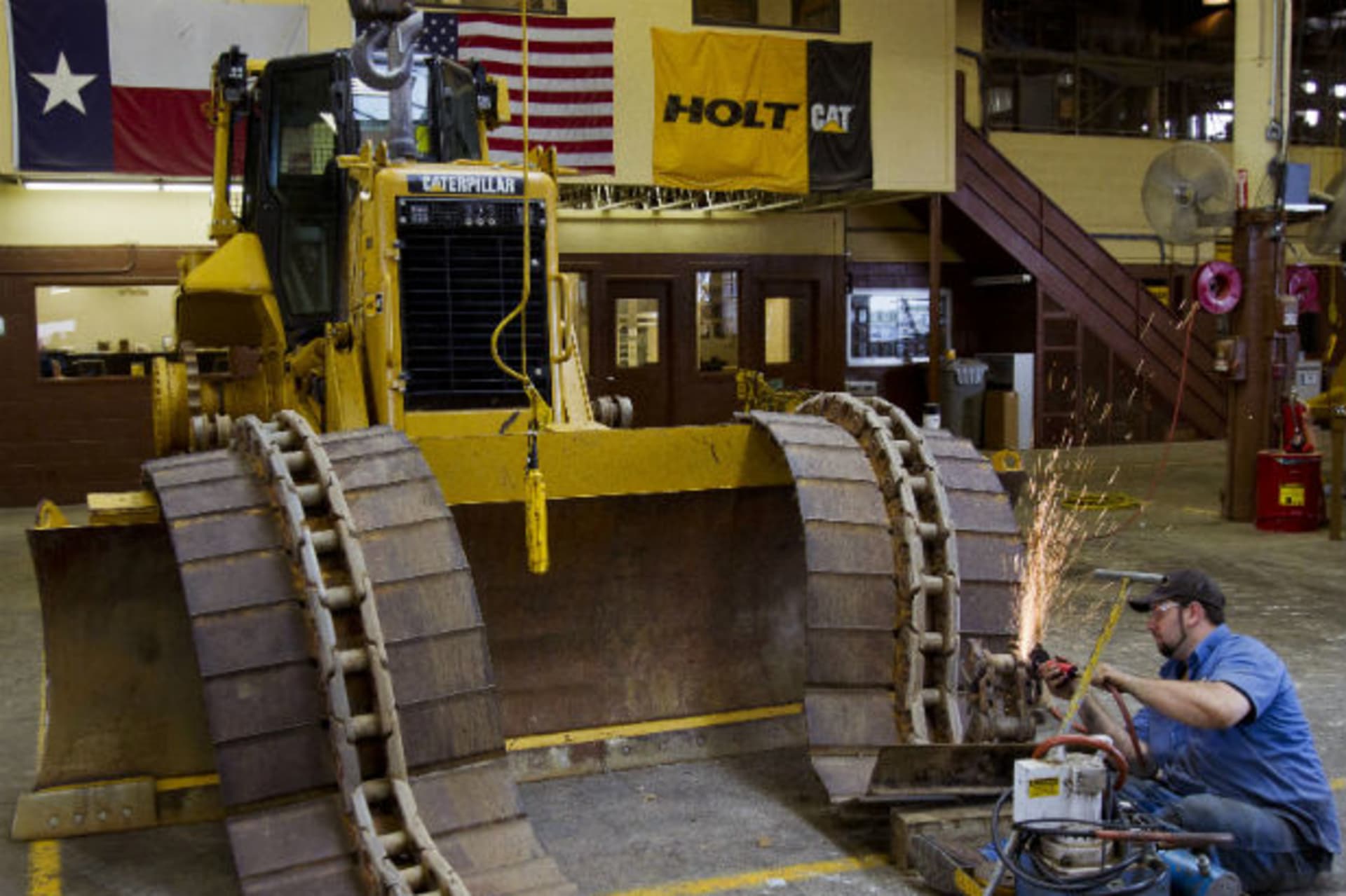 <p>Michael Hill works on the track of a Caterpillar bulldozer at Holt Caterpillar, the largest Caterpillar dealer in the United States, in San Antonio, Texas on March 19, 2012 (Richard Carson/Courtesy Reuters).</p>
