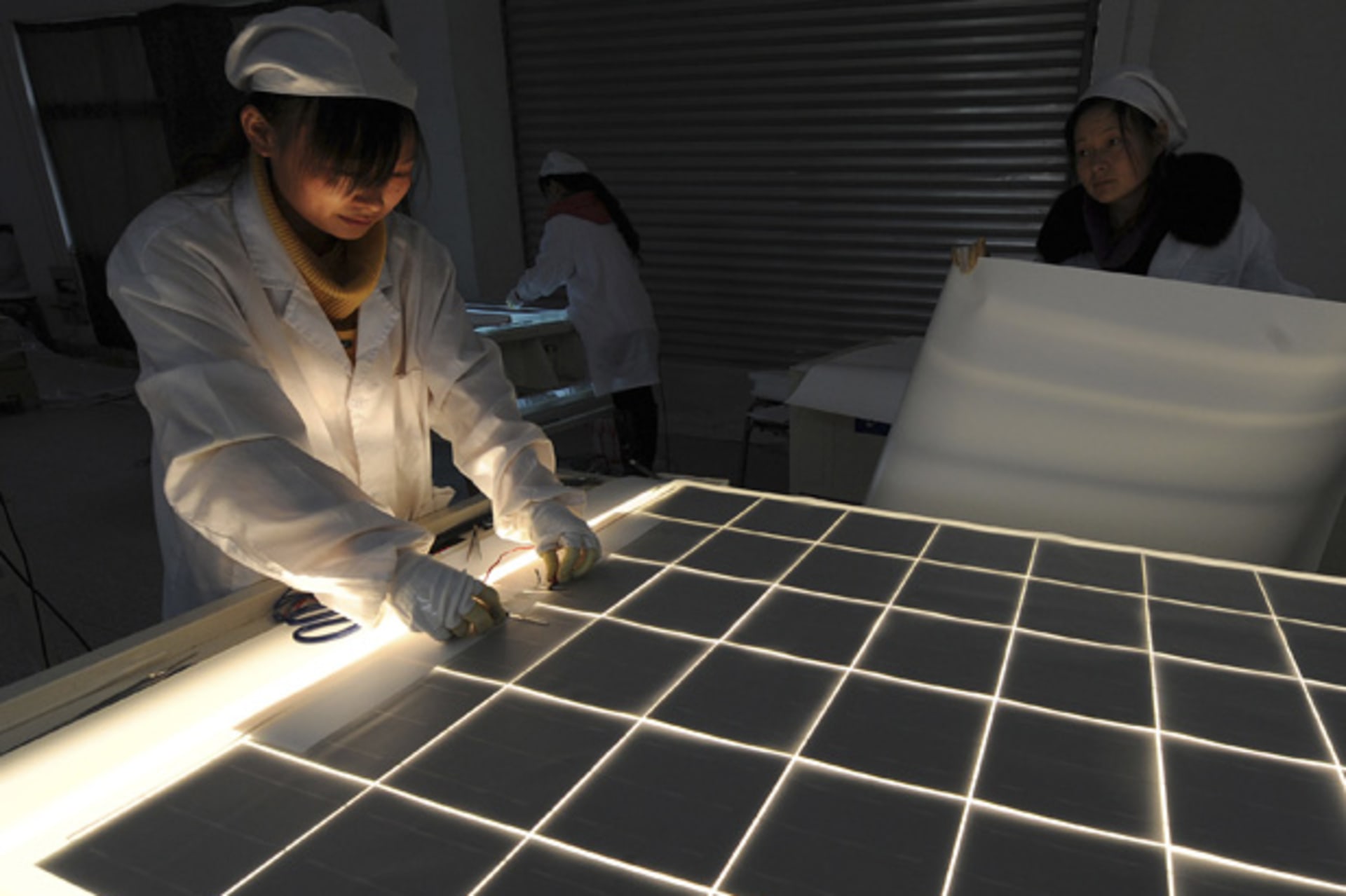 <p>Employees work on a solar panel production line at a solar company workshop in Hefei, China (Stringer/Courtesy Reuters).</p>
