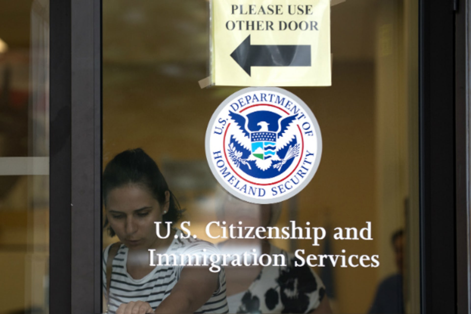 <p>A woman leaves the U.S. Citizenship and Immigration Services offices in New York on August 15, 2012 (Keith Bedford/Courtesy Reuters).</p>
