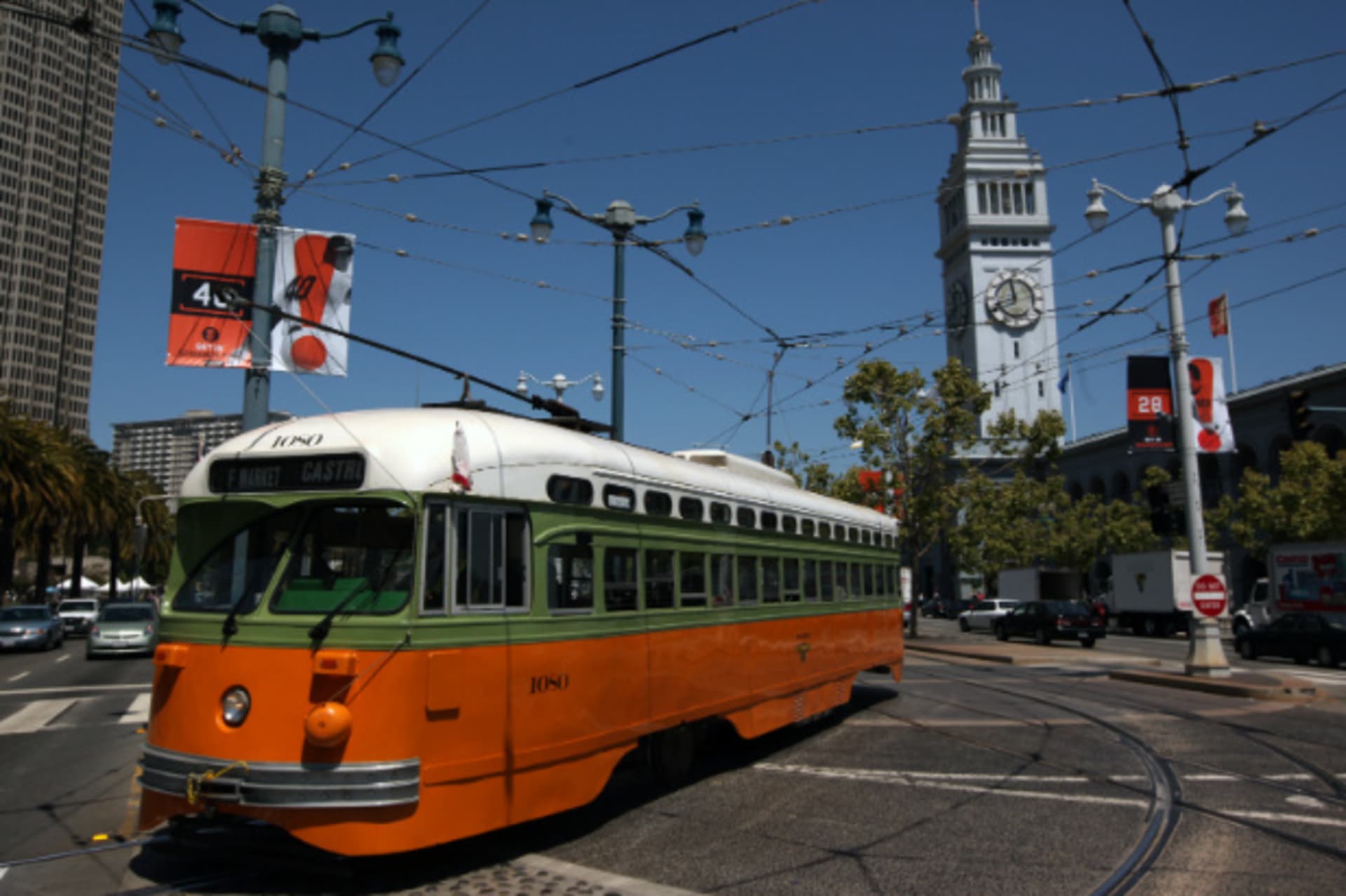 <p>A brightly colored streetcar moves past the Ferry Building in San Francisco in May, 2012 (Robert Galbraith/Courtesy Reuters).</p>
