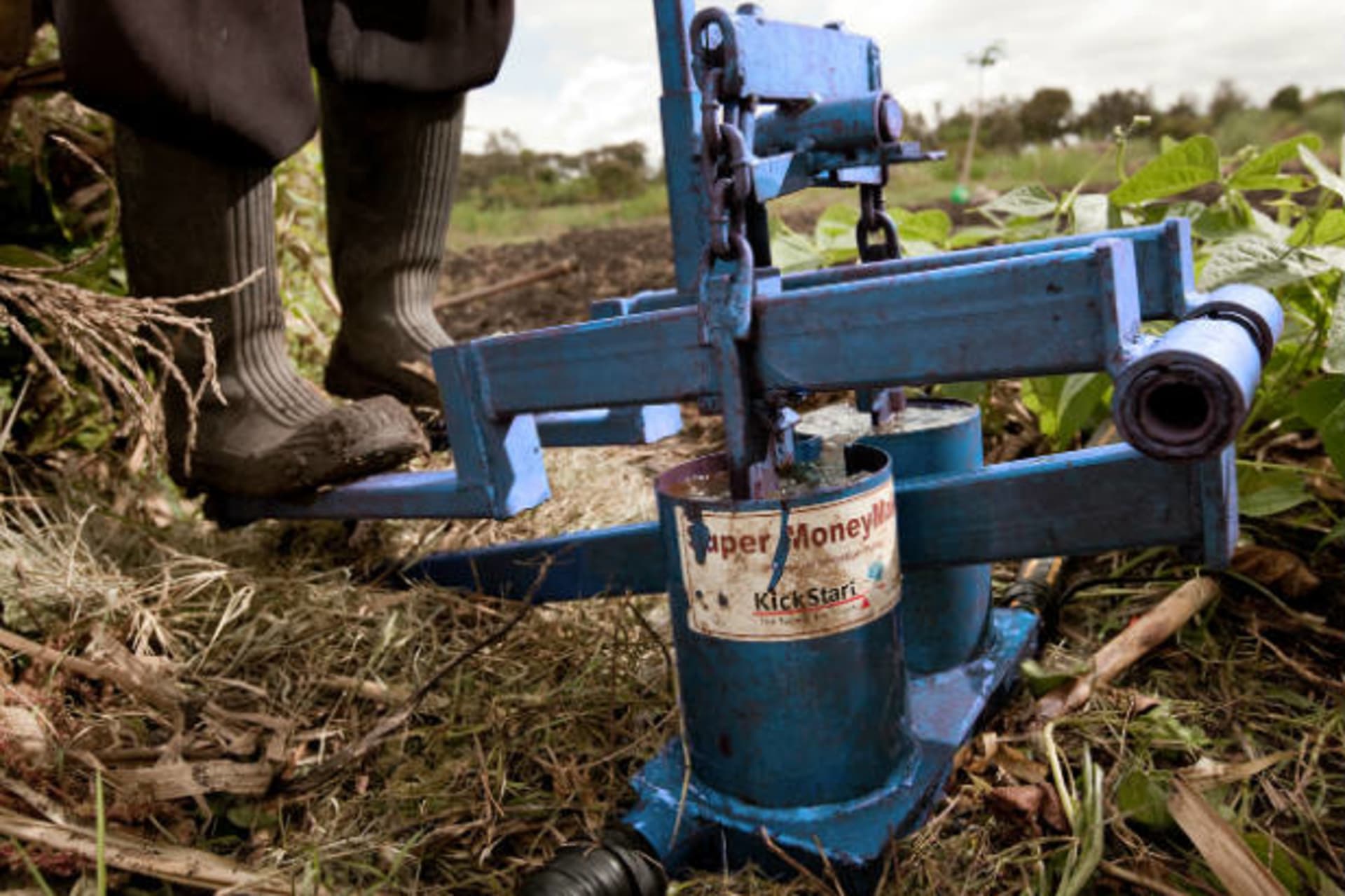 <p>A farmer uses one of KickStart’s pumps to irrigate farmland in Africa (Courtesy KickStart).</p>
