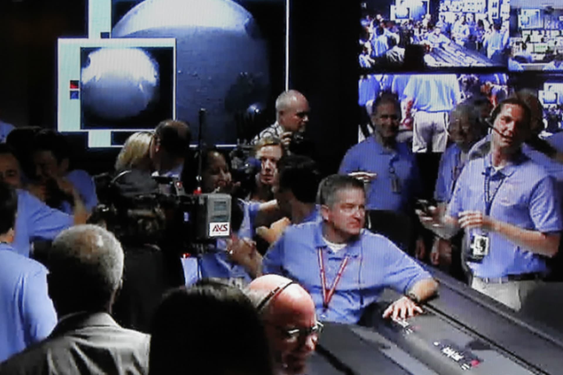 <p>NASA engineers celebrate the successful landing and first images from the Curiosity rover at the Jet Propulsion Lab in Pasadena, California (NASA Handout/Courtesy Reuters).</p>
