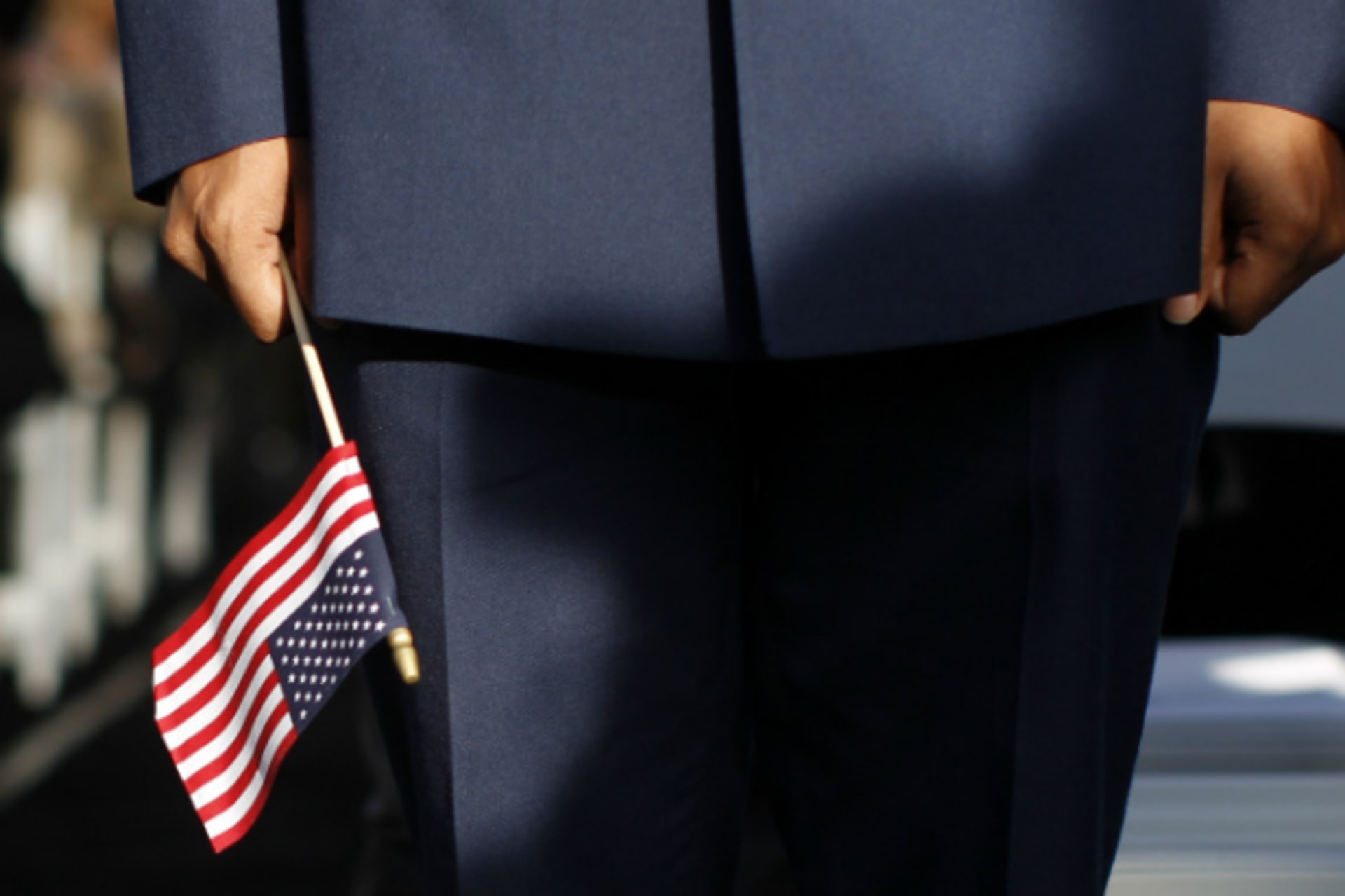 <p>A new U.S. citizen holds an American flag during a naturalization ceremony (Mike Segar/Courtesy Reuters).</p>
