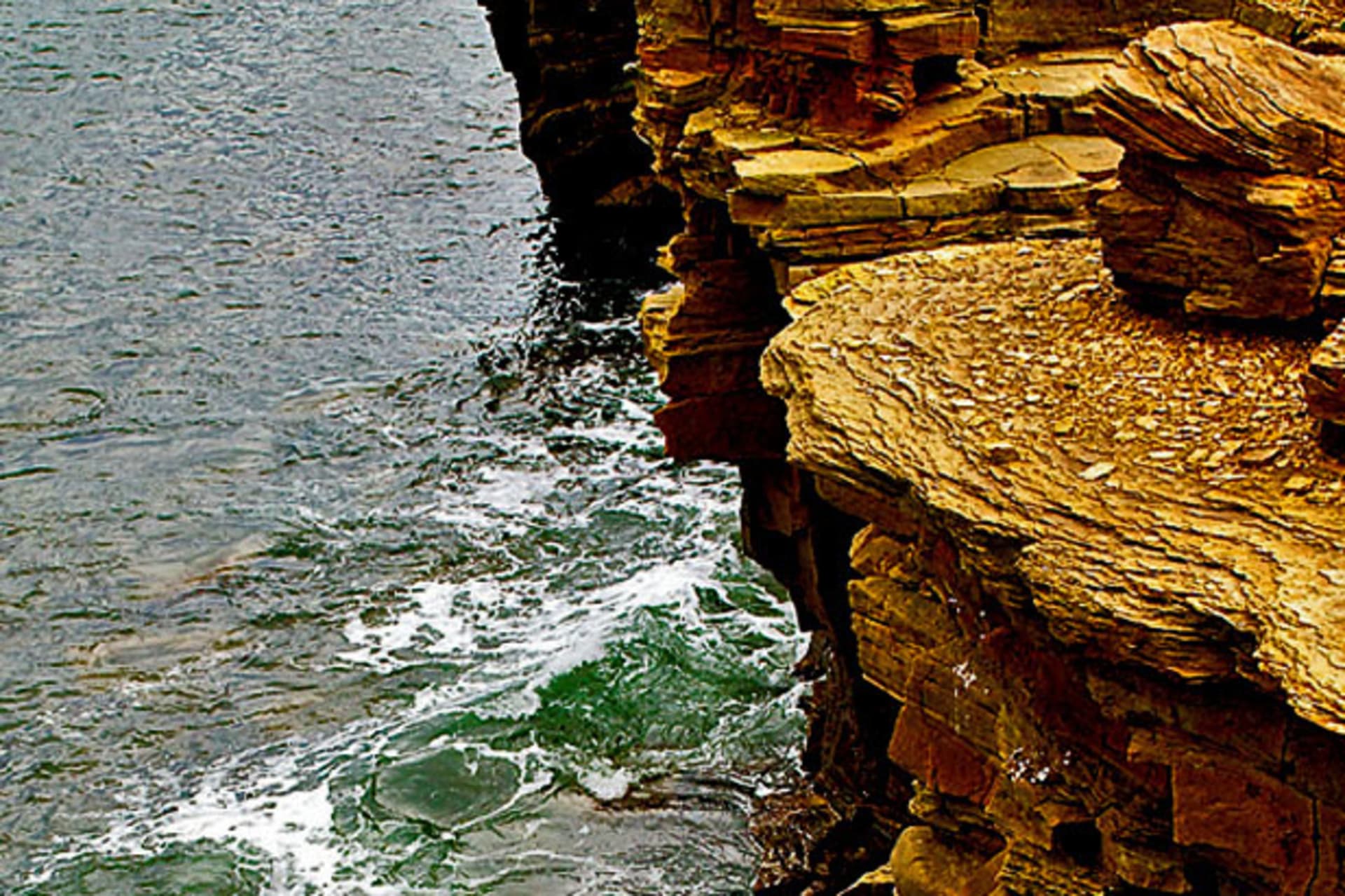 <p>Cragged bluffs rise from the sea. (Courtesy Darren Harmon).</p>