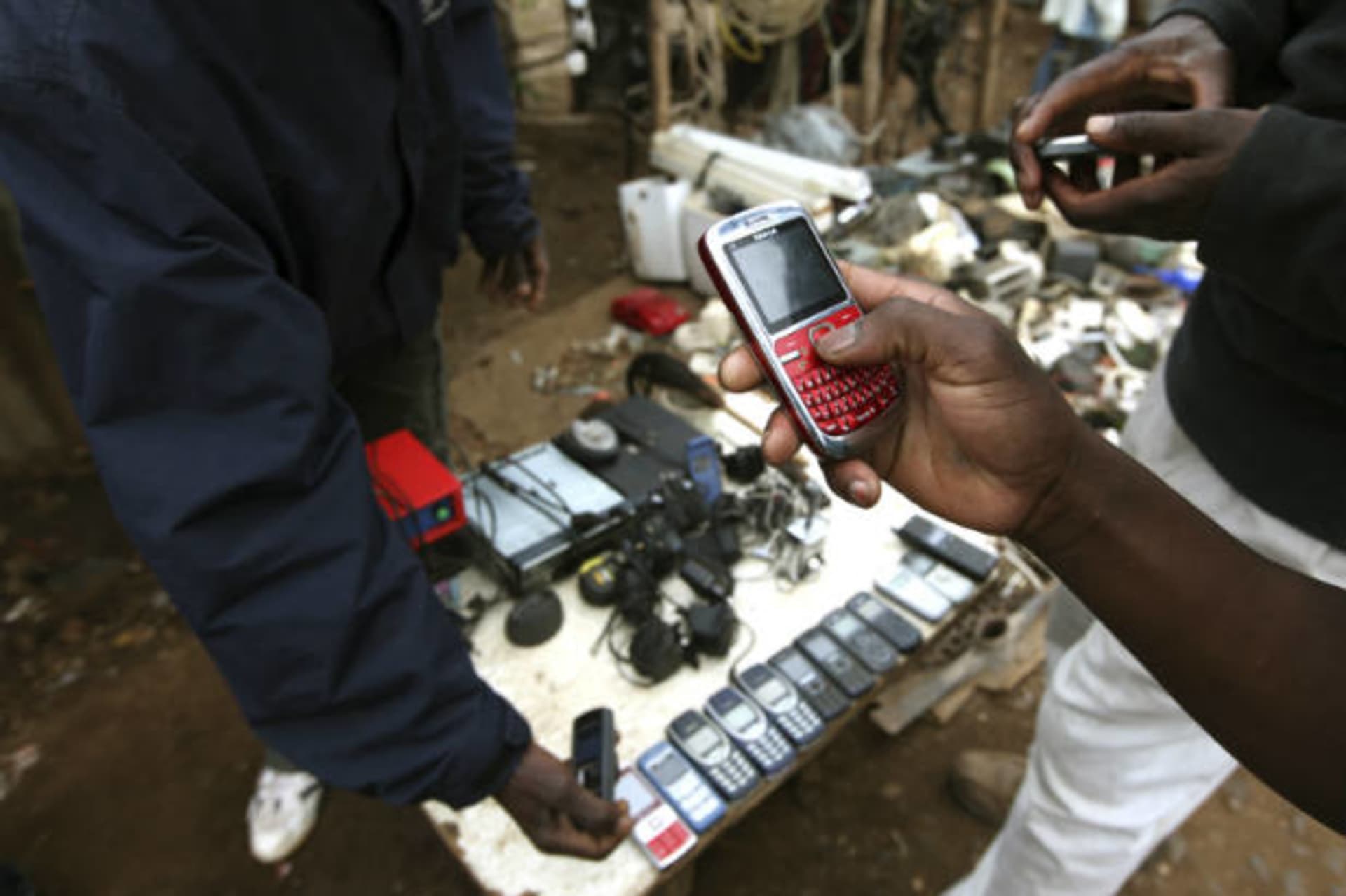 <p>A vendor hawks second-hand mobile phones at the sprawling Kibera slum, one of the largest and poorest slums in Africa, near Ke…ne of the largest and poorest slums in Africa, near Kenya’s capital Nairobi on August 26, 2011 (Noor Khamis/Courtesy Reuters).</p>
